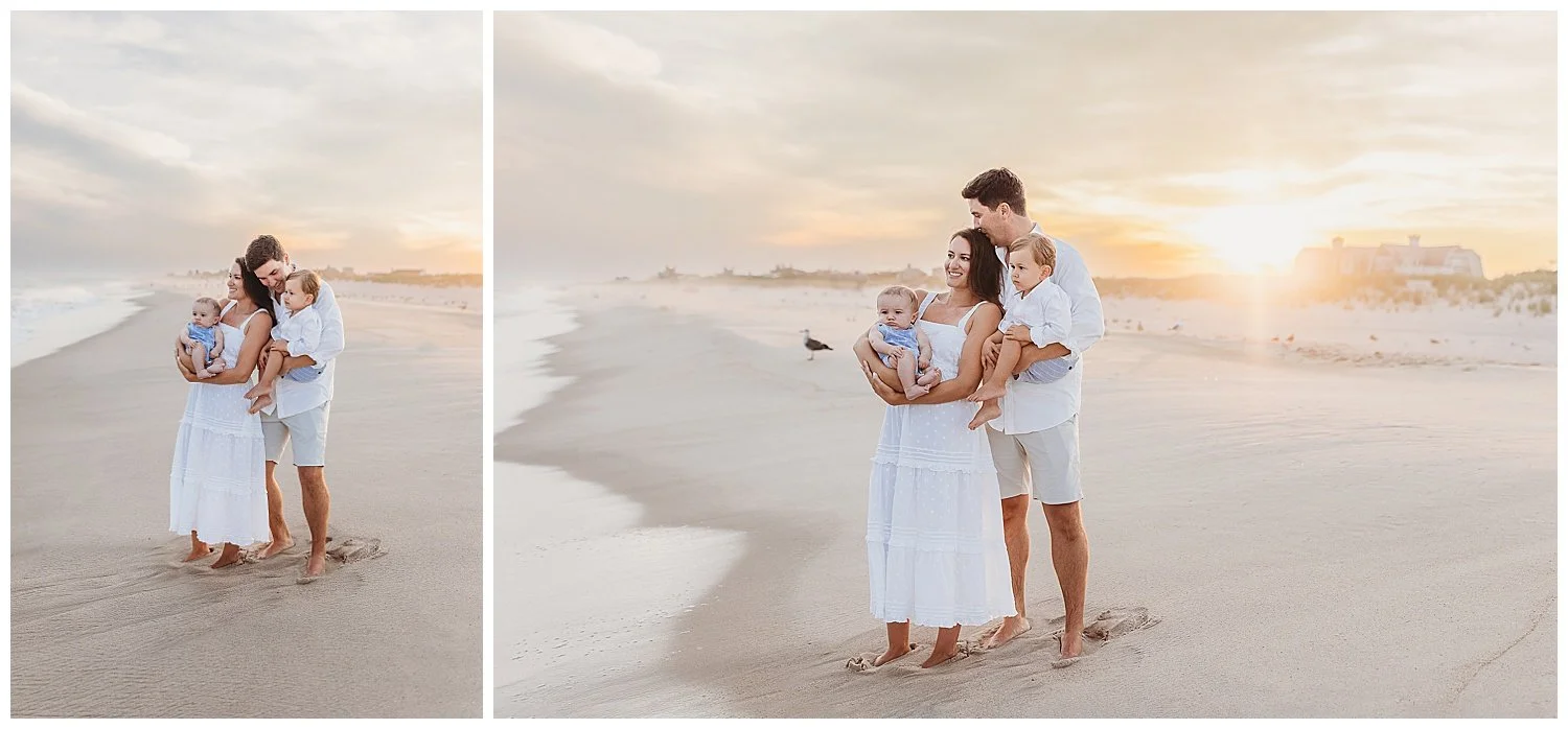 family standing at the ocean's edge at sunset kissing