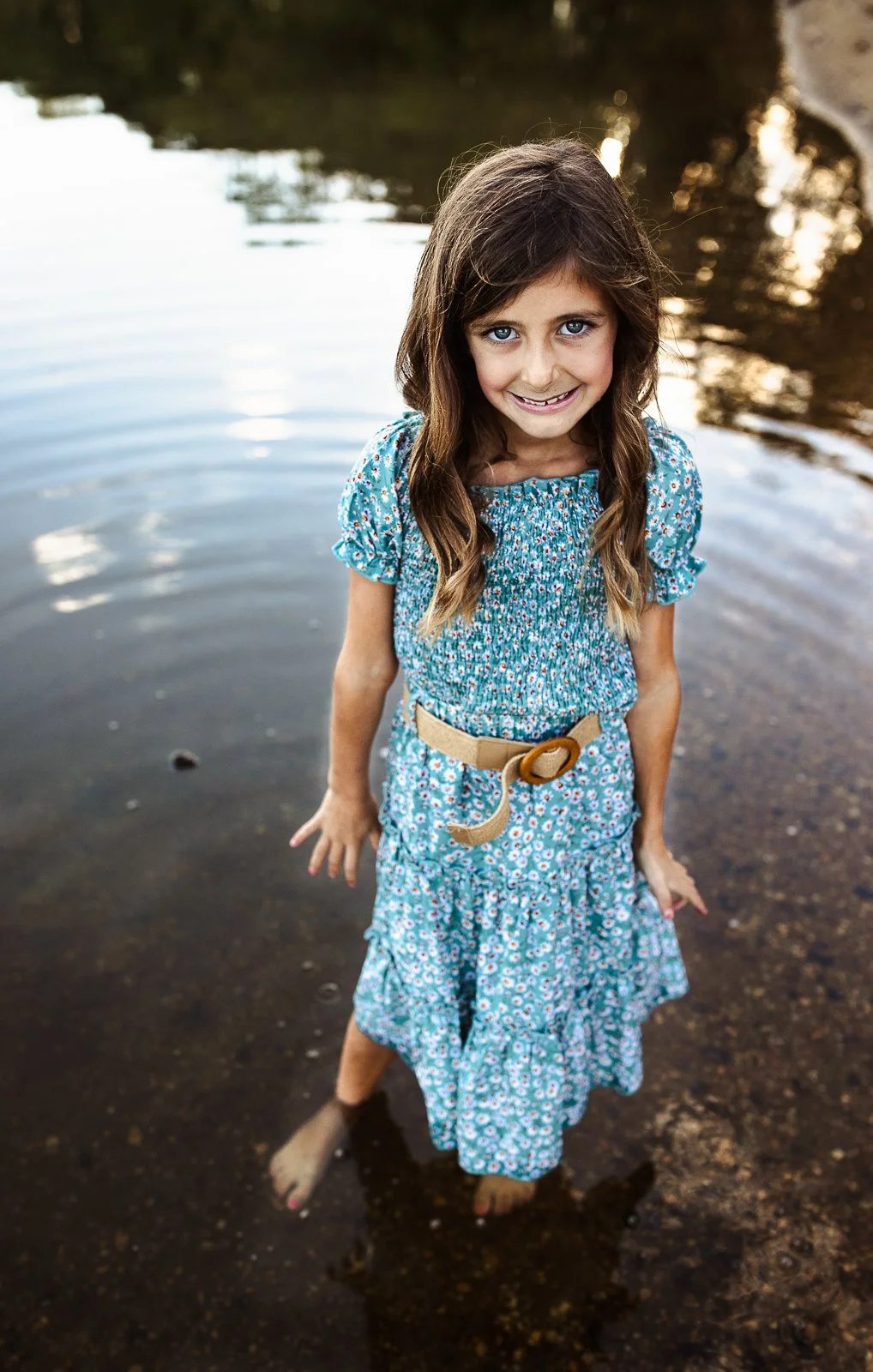 bohemian styled kids photo session in a lake at sunset