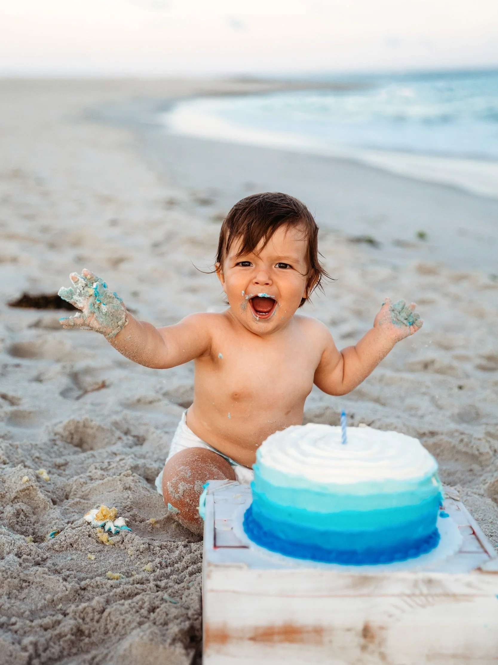 Beach cake smash sessions are a thing and they are exactly as fun as they look.  The best part about them is your family can easily be included. We start with the sweet family portraits and end with cake.  Yes, it is messy and icing gets  absolutely 
