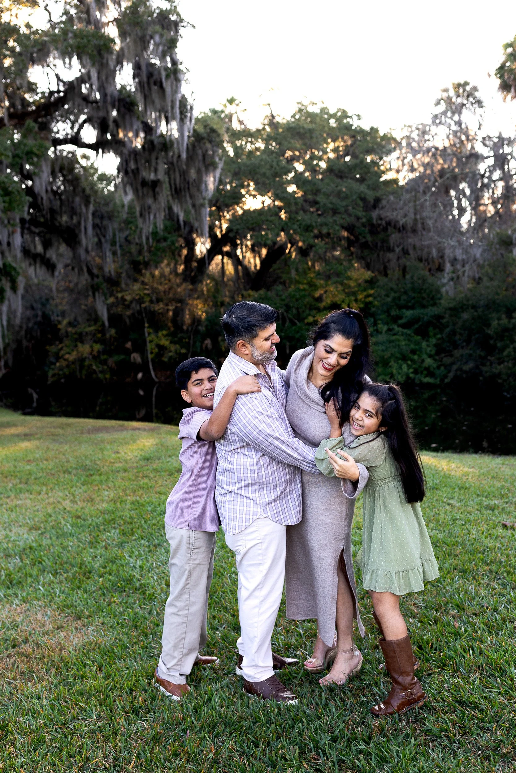 family photography at sawgrass Marriott, mother kissing son in a bay at sunset