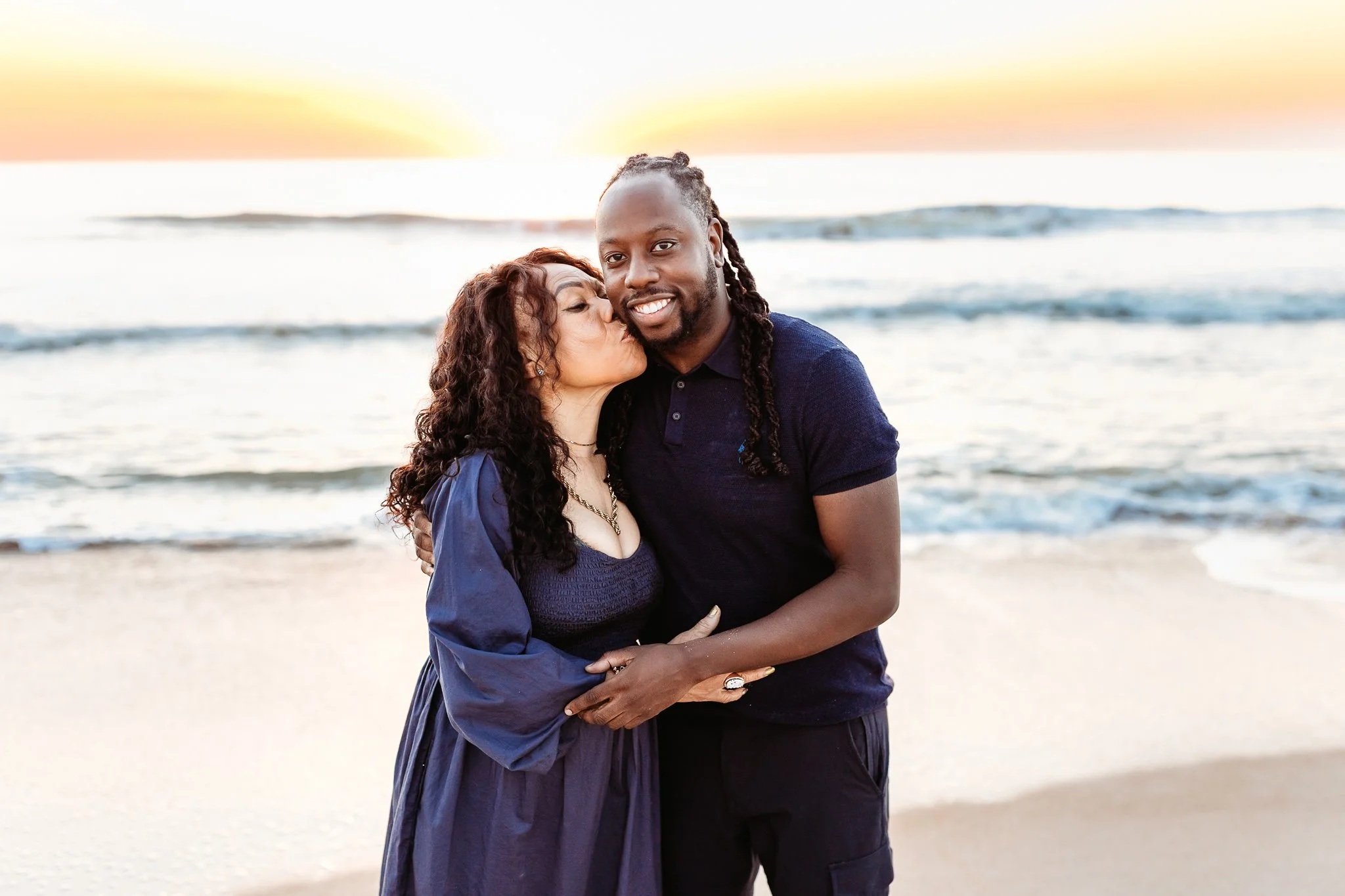 mother holding her children in soft morning light during a beach photo session