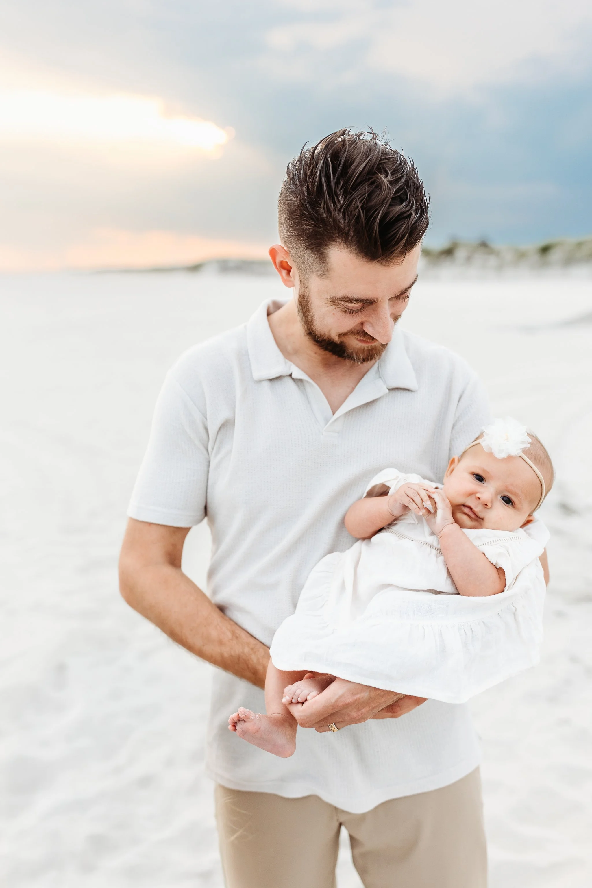 dad holding baby and looking at her