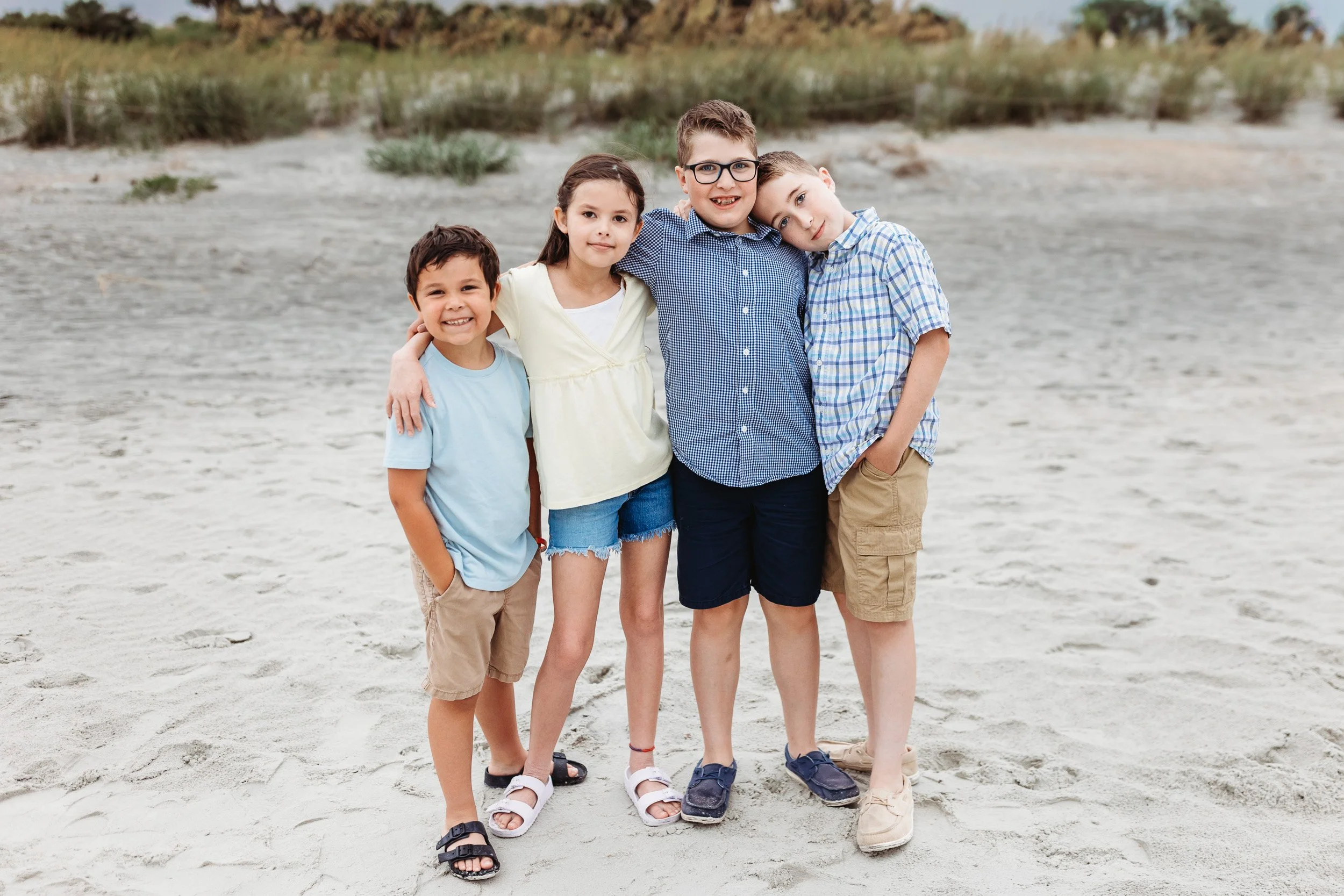 cousins embraced on Mickler's beach at sunrise for photos