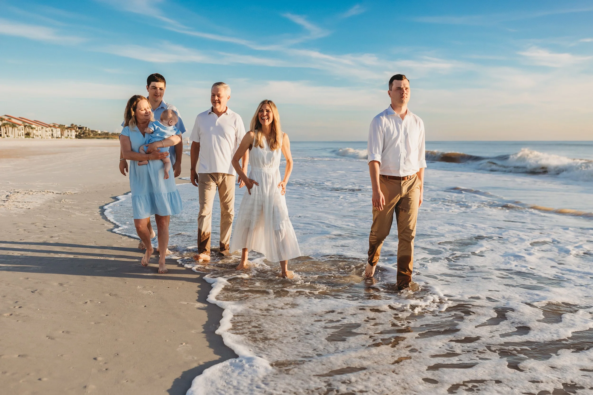 family walking along the beach at the end of a vacation family photo session