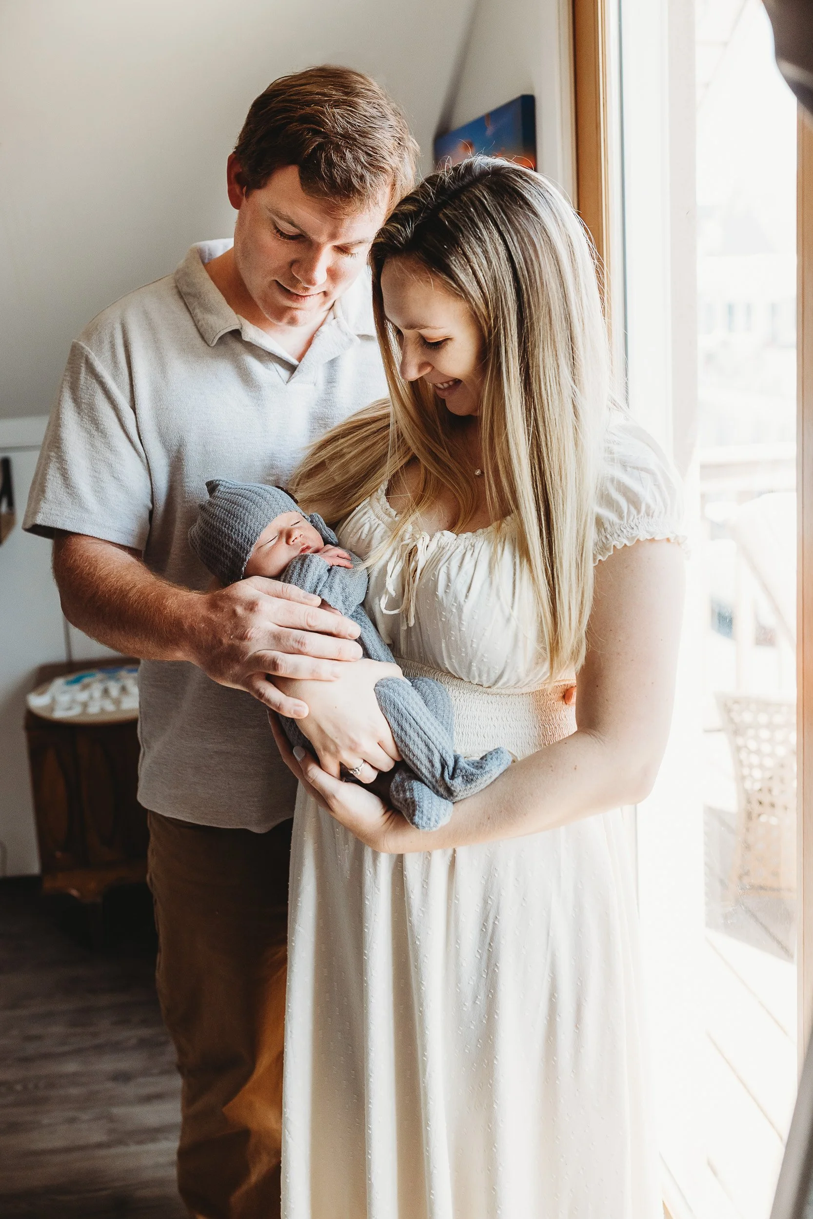 Parents holding newborn together natural candid newborn photography Atlantic Beach Florida