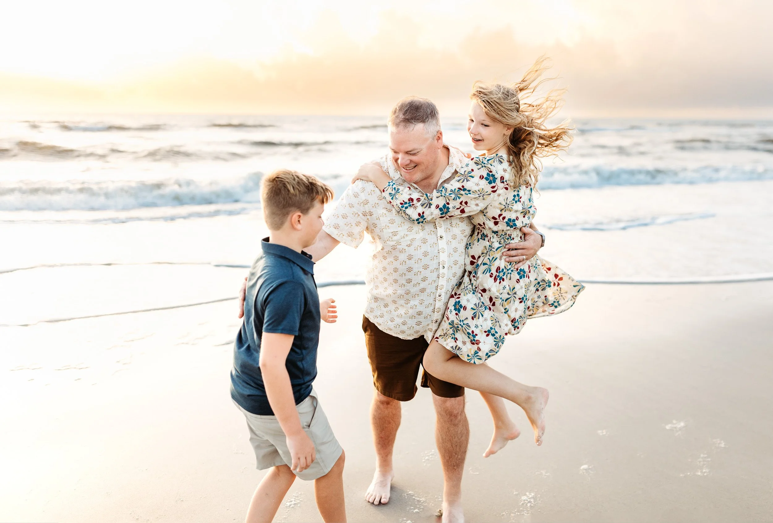 kids jumping on their dad and laughing and playing