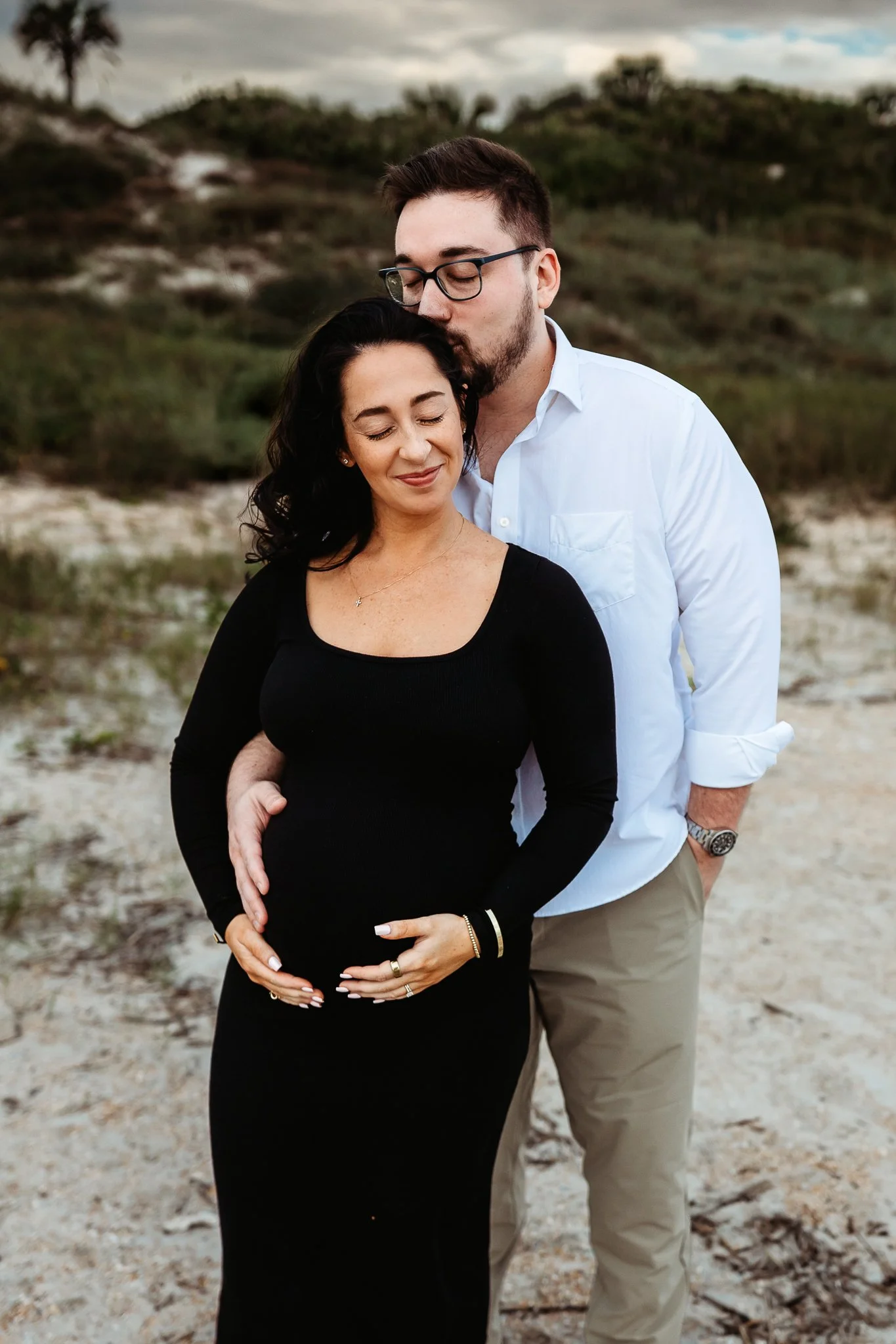 Pregnant mother holding her belly during a beach maternity session in Ponte Vedra.