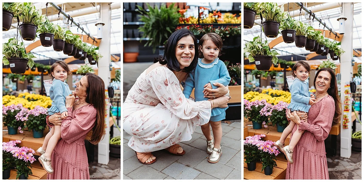 grand,a holding toddler girl and they are surrounded by flowers in a greenhouse