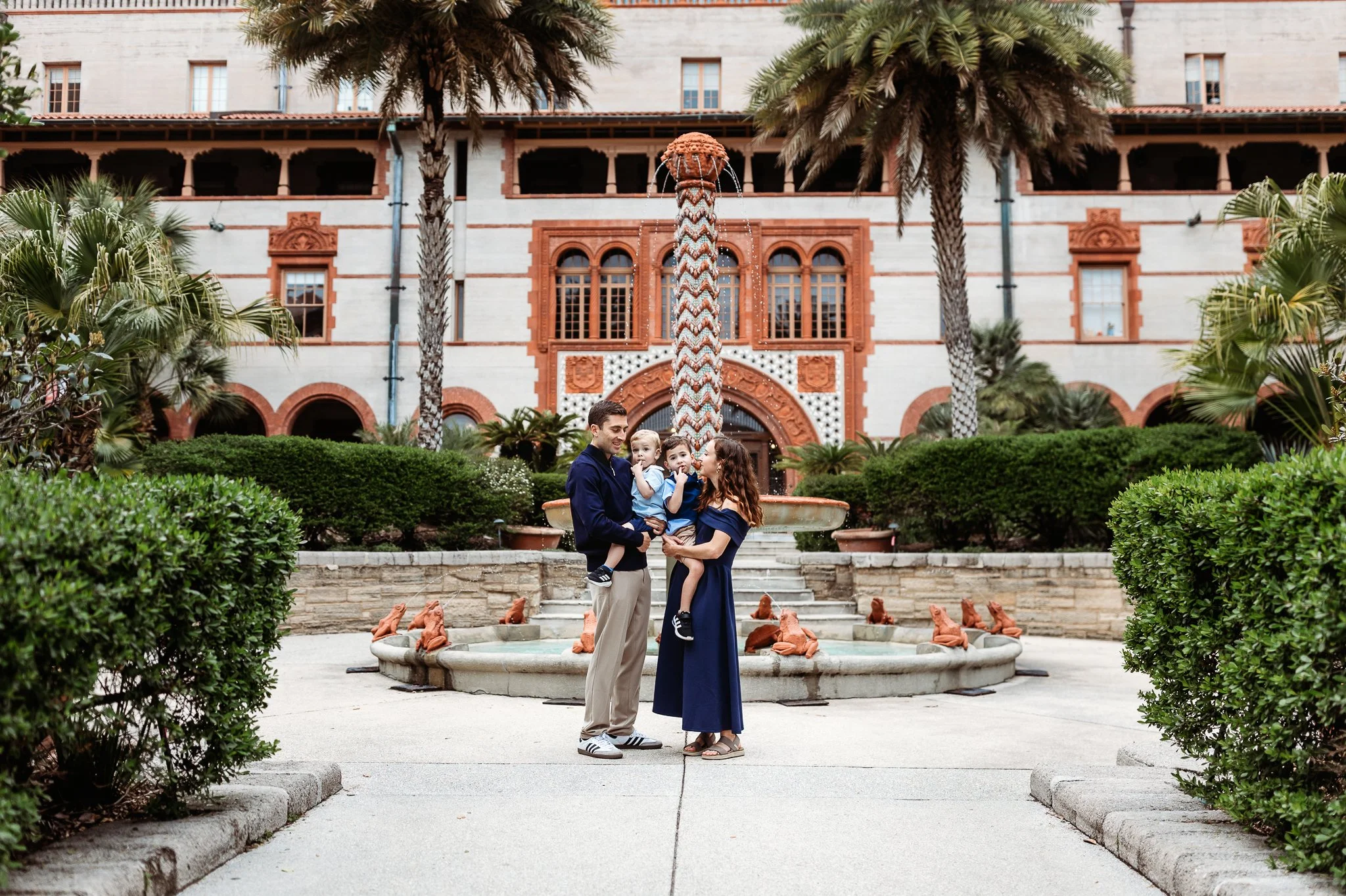 family embraced in the courtyard of Flagler in front of the fountain for family pictures