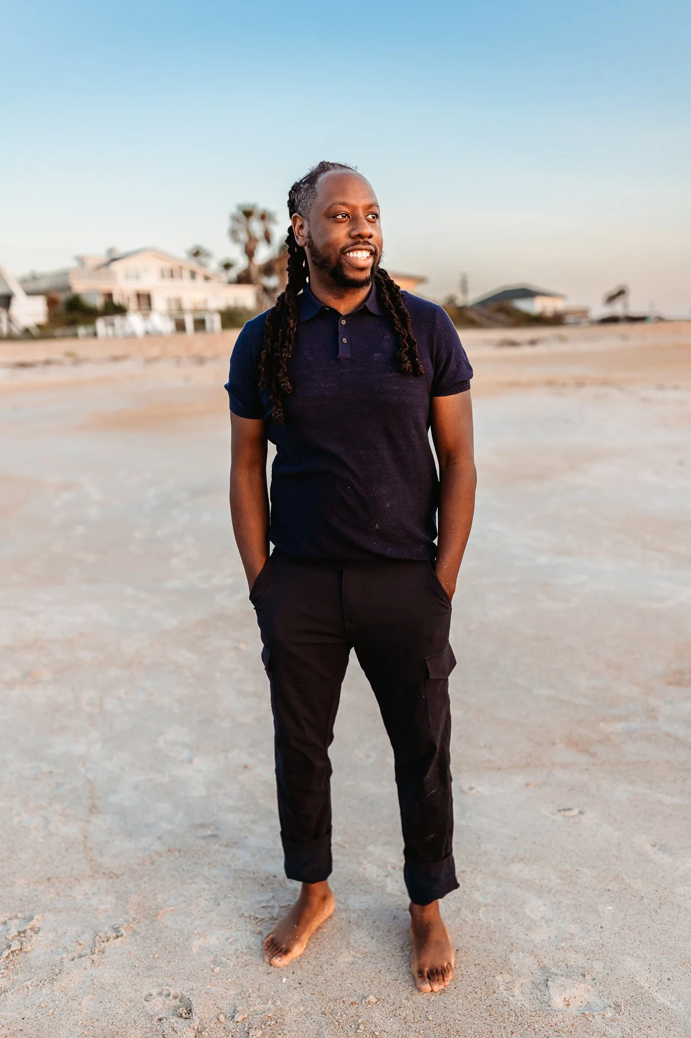 man looking out in distance at sunrise during family photos at Ponte Vedra Beach