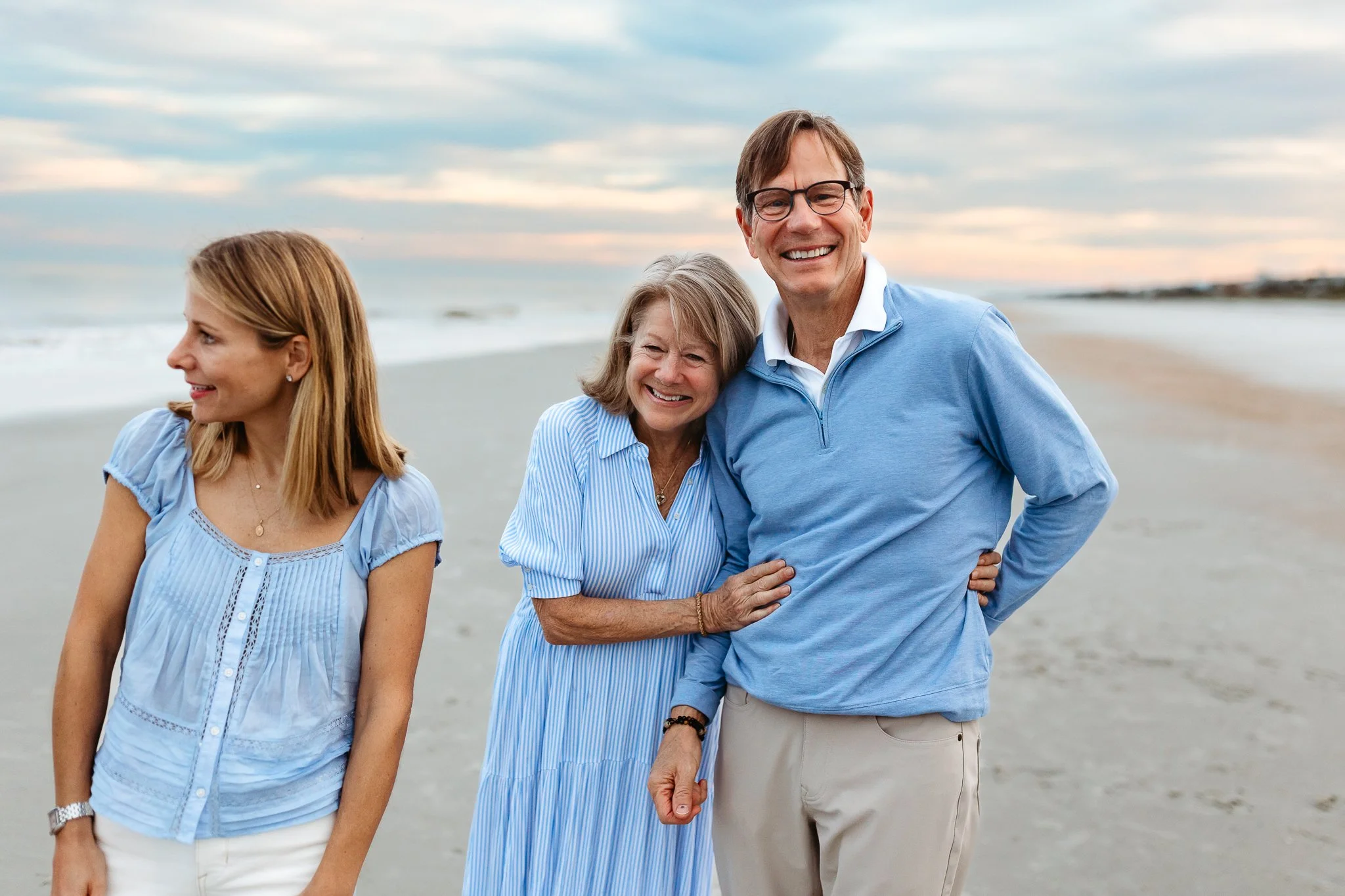 grandmother embracing husband and laughing on the beach