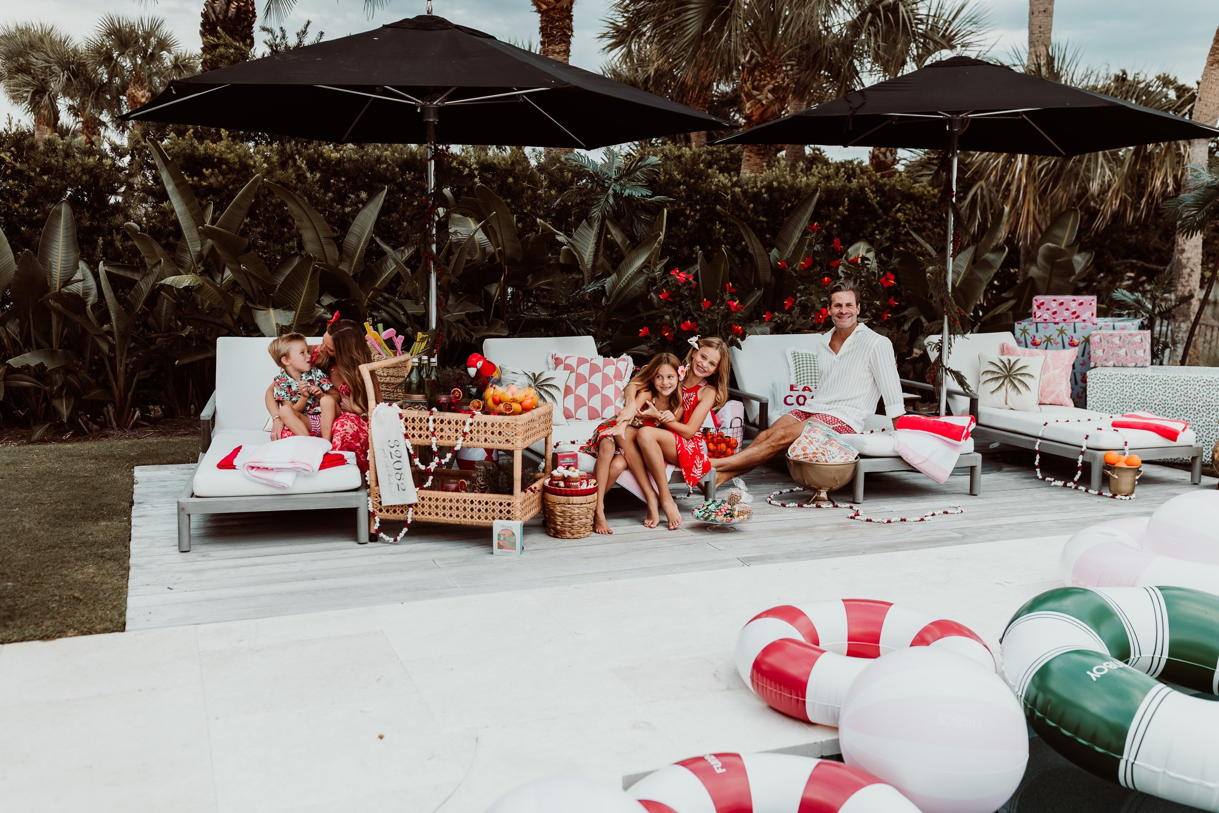 Family wearing red and green tropical prints for Florida holiday photos