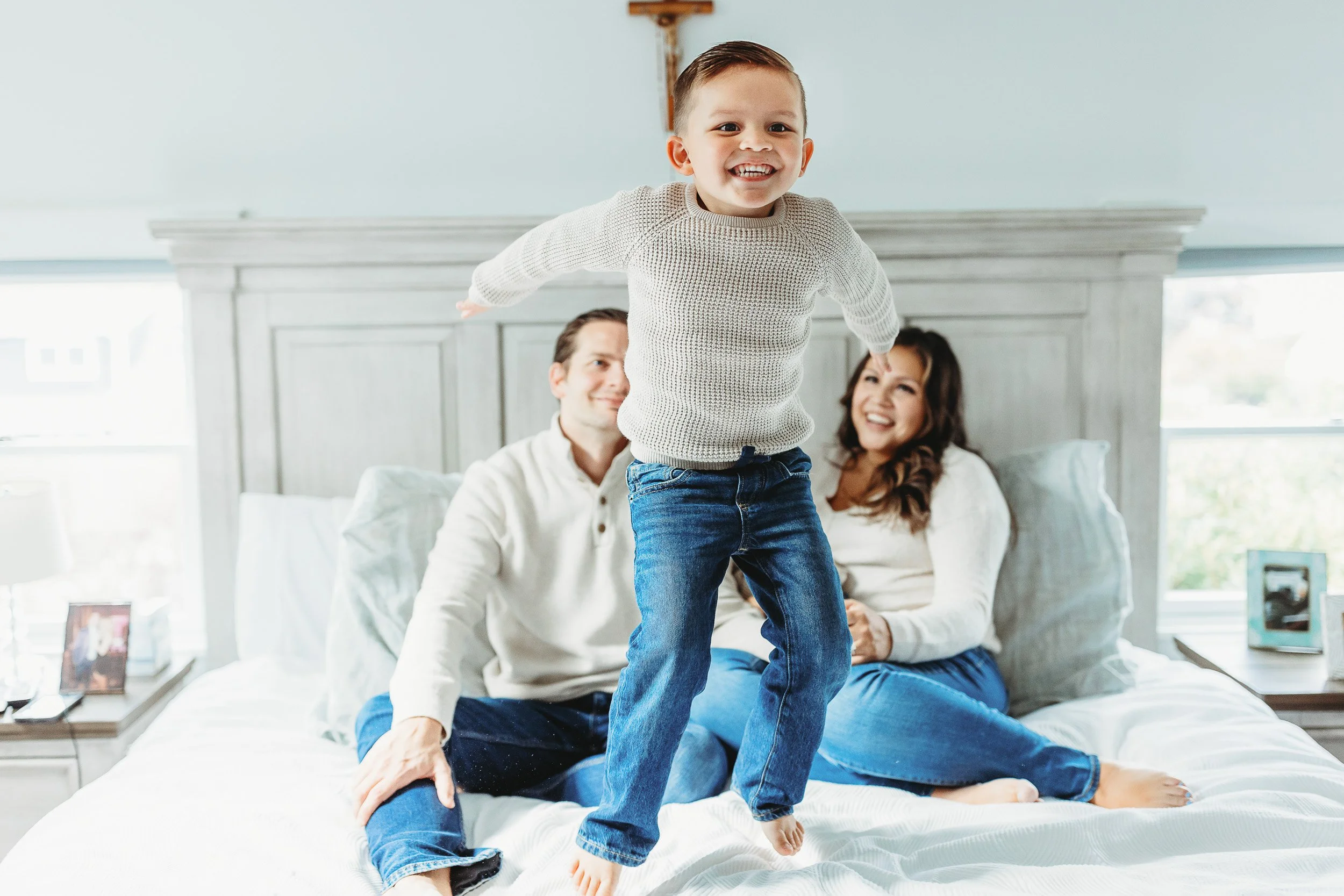 toddler jumping on a bed in a home to get energy out