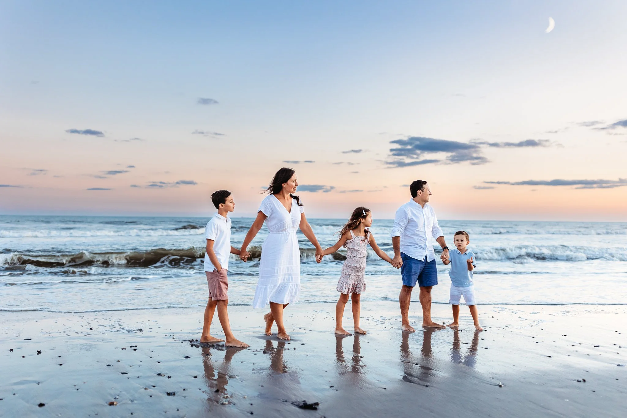 Coordinated beach family photo outfits in cream and soft blue