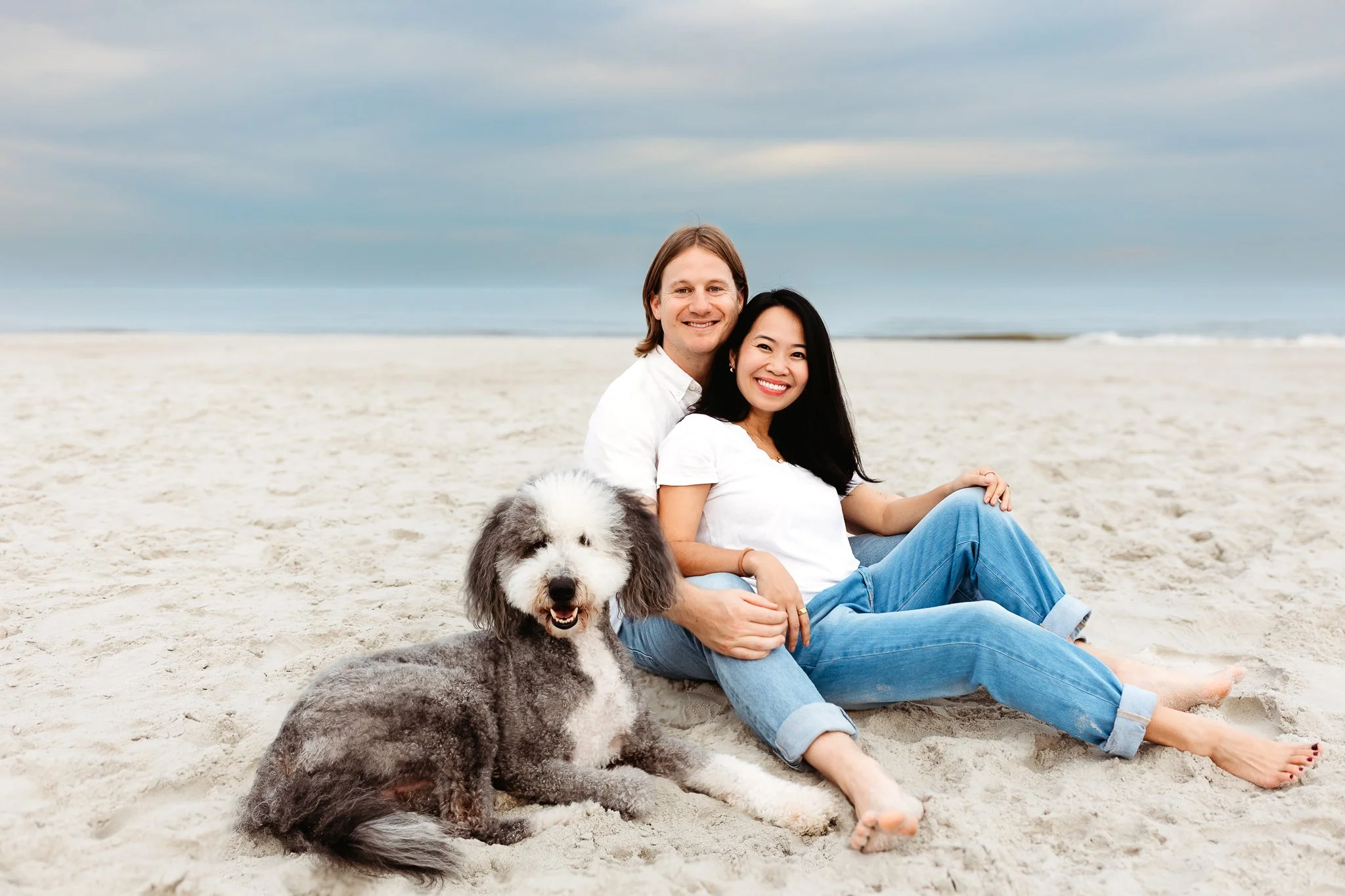 pregnant woman and husband with dog for family photos