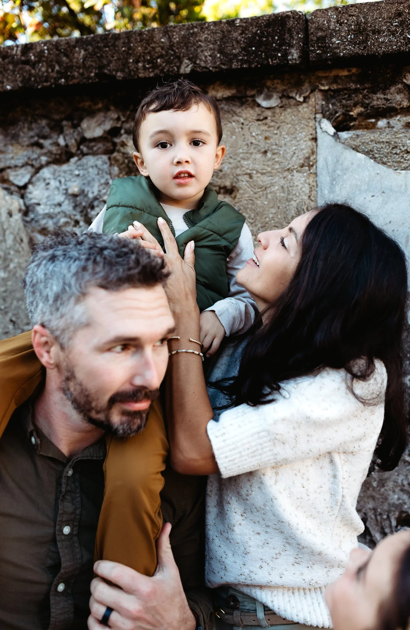 candid and emotional photo os a family in front of a coquina wall in st augustine