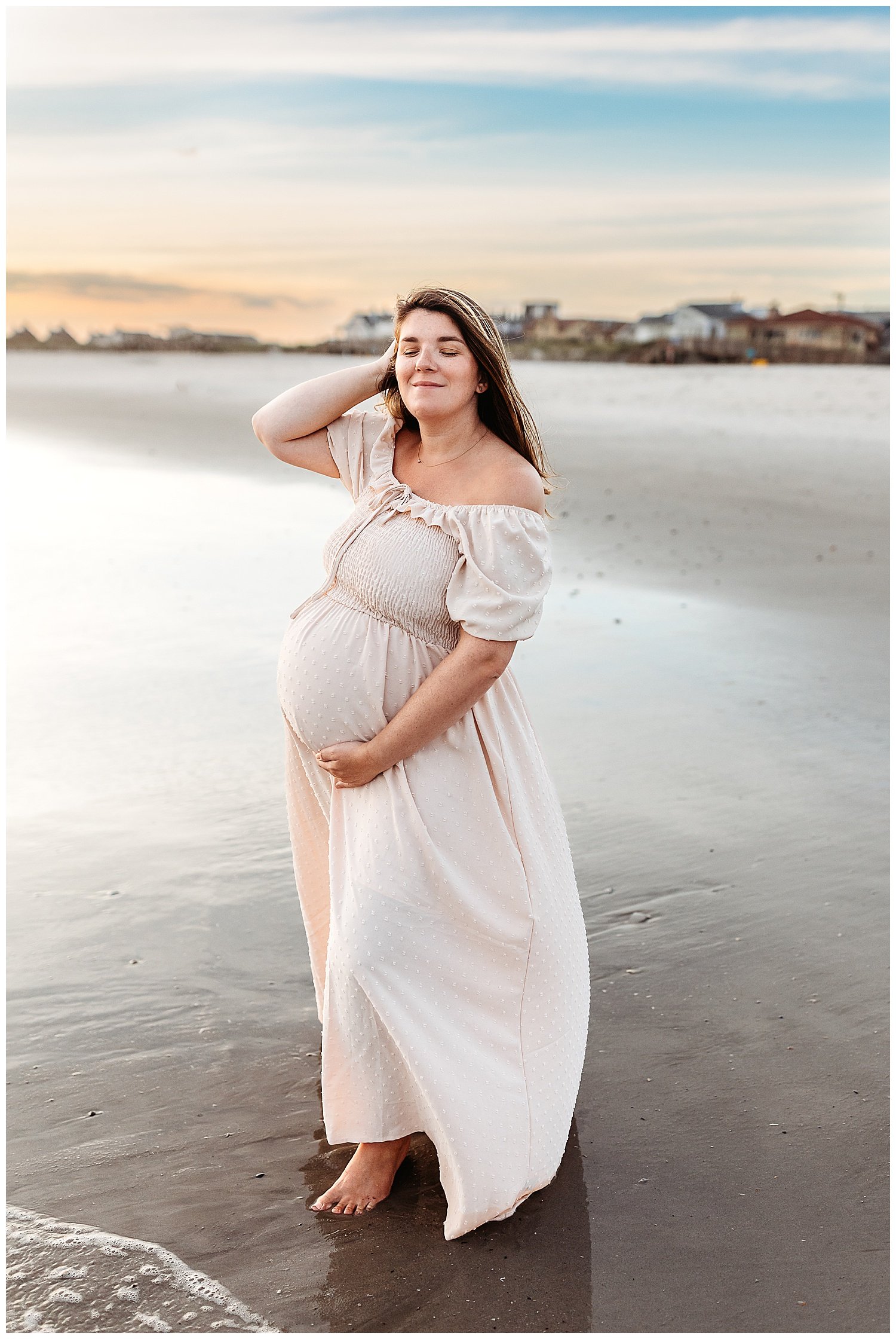 woman who is preheat in free people oasis dress with eyes closed int he ocean
