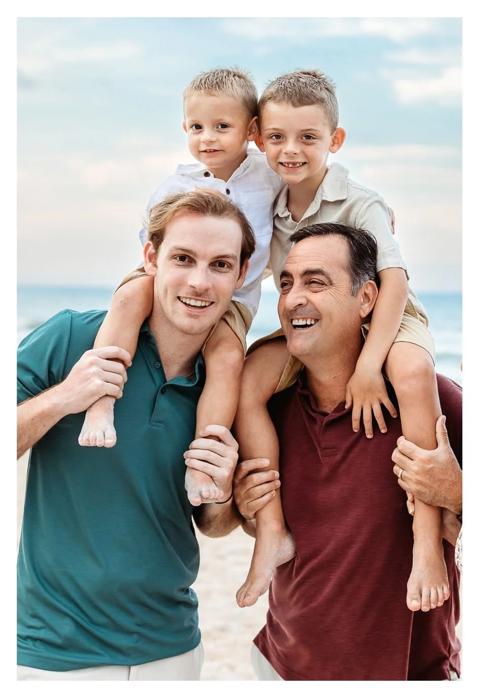 grandpa and dad with children on shoulders laughing