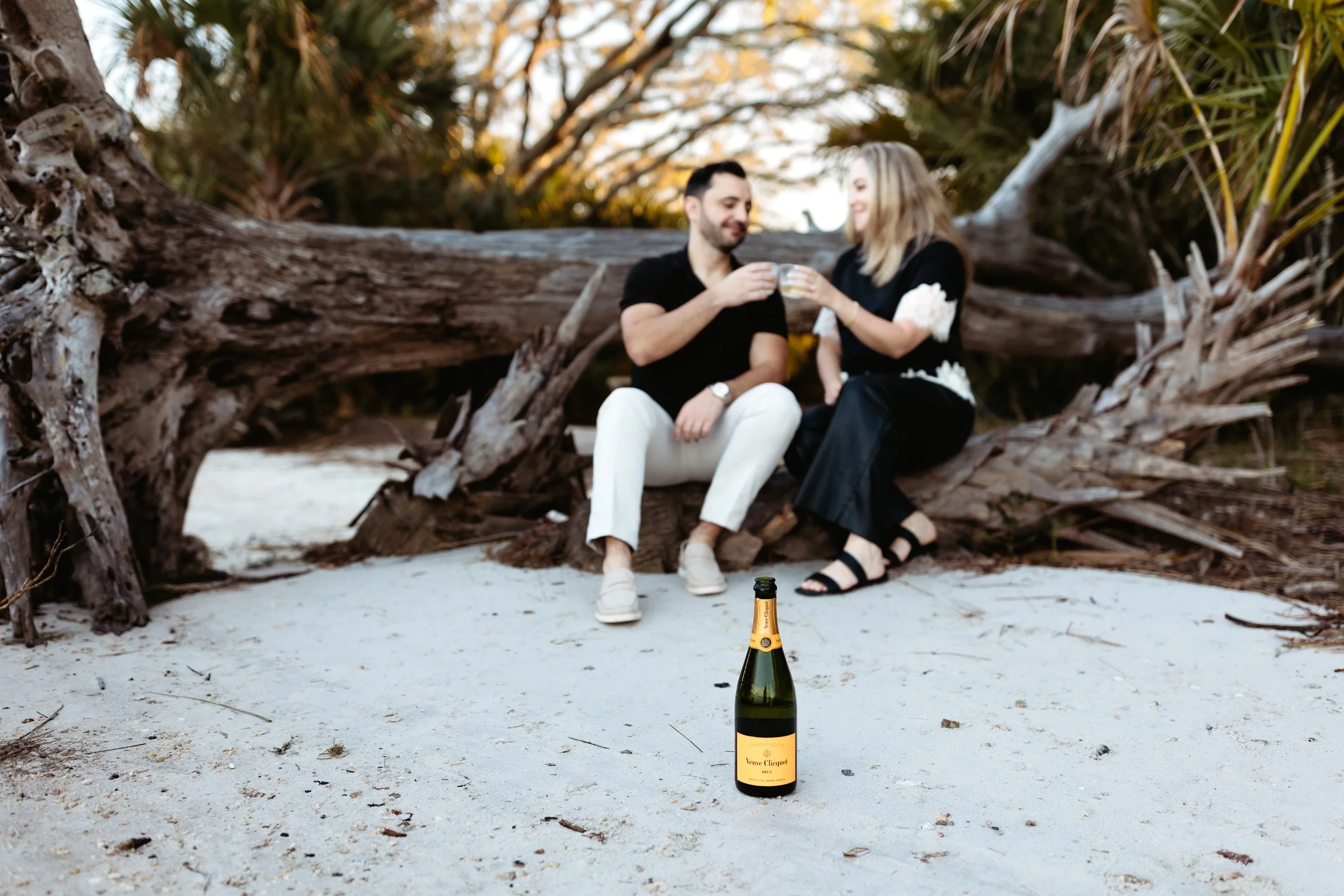 couple drinking champagne during engagement photos