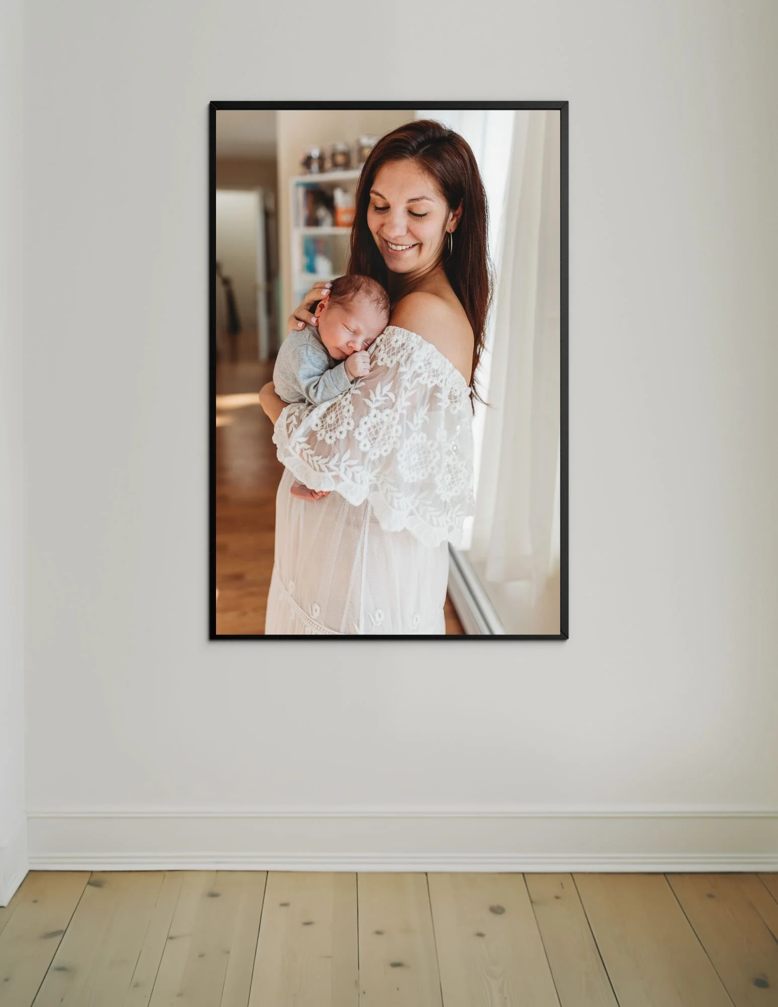 large image of a mom holding newborn during her Jacksonville in home newborn portraits