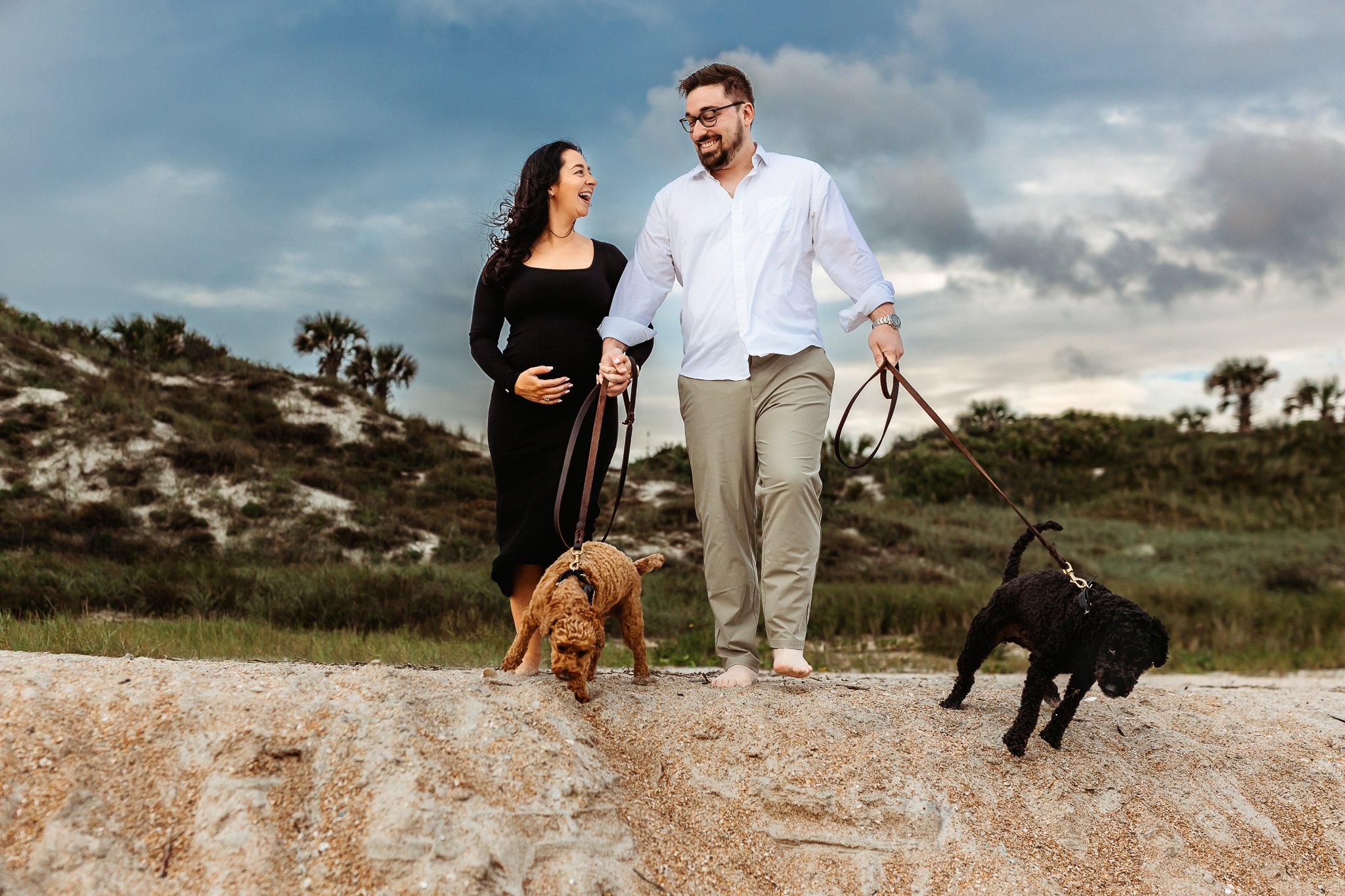 Expecting couple with their dogs during a beach maternity session at Guana North in Ponte Vedra.