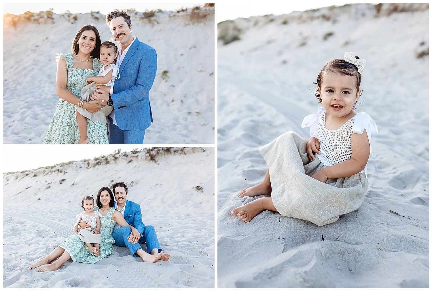 family dressed in blue sage green and white seated on the sand at the beach in front of a dune