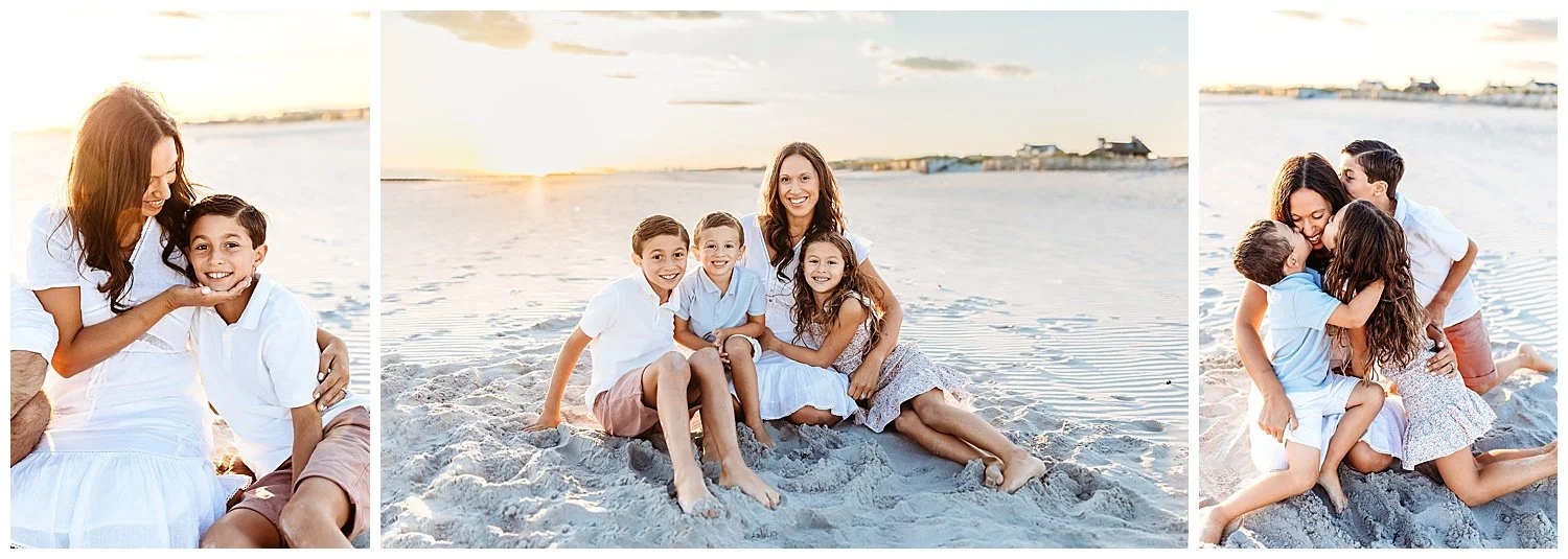 family in white and pink seated on a beach with a soft golden glow of sunset behind them