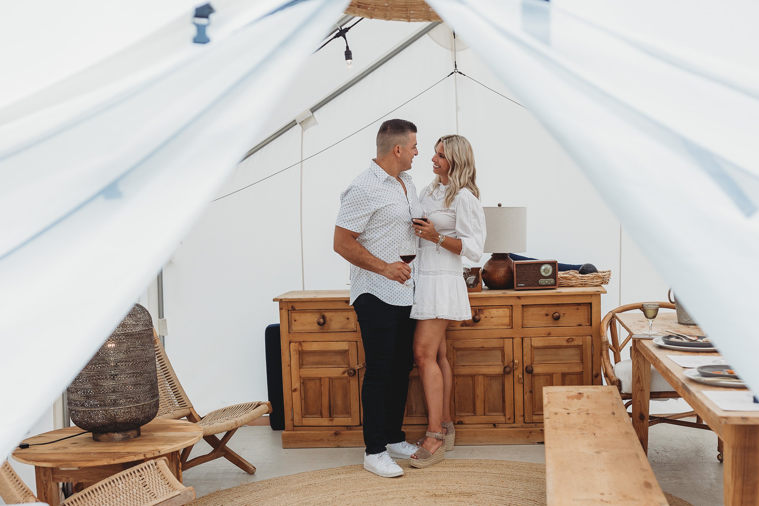 couple in a tent drinking wine on a date at a lounge in Jacksonville