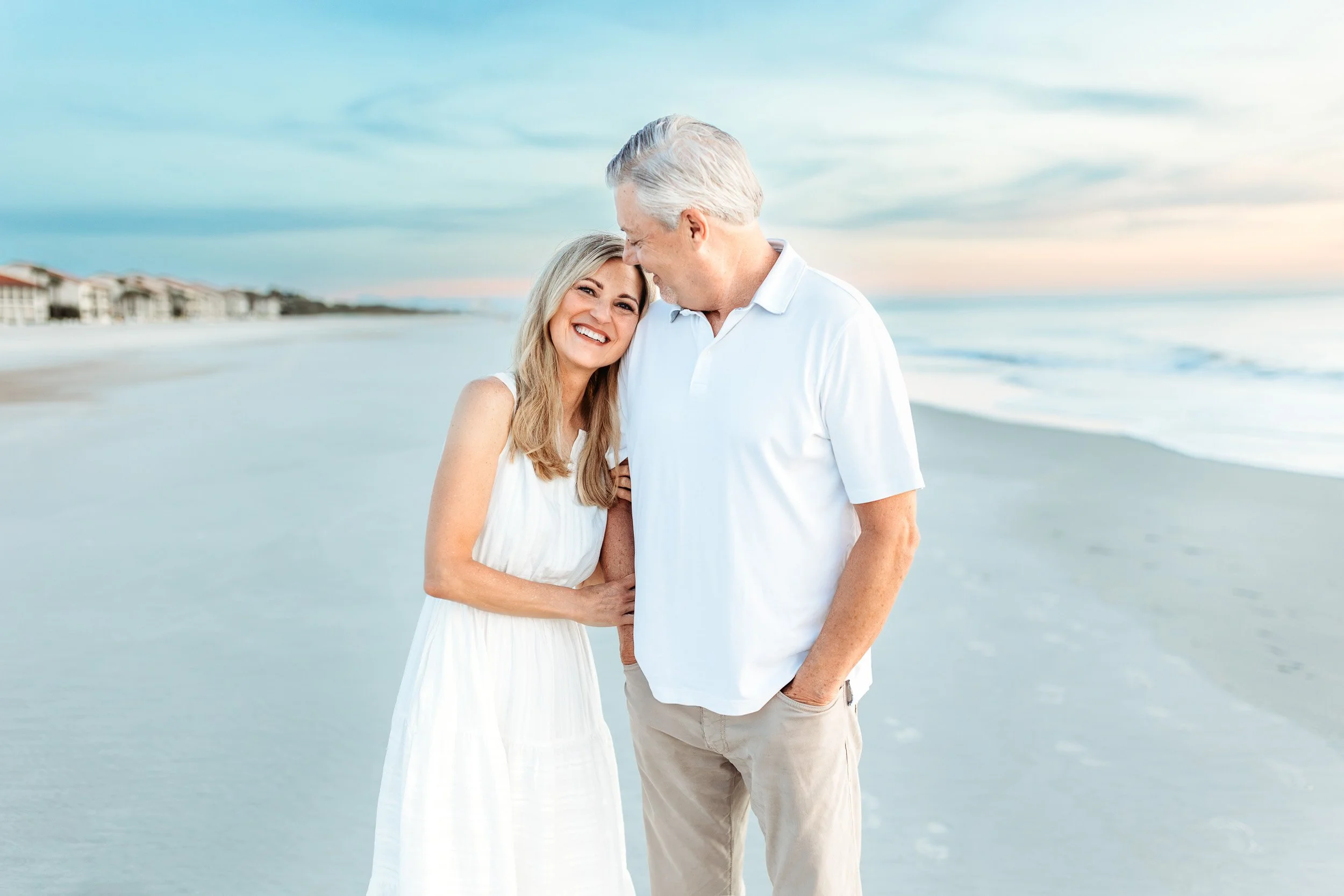 grandparents embraced on the beach at sunrise for vacation family photos at the Ponte Vedra inn and club
