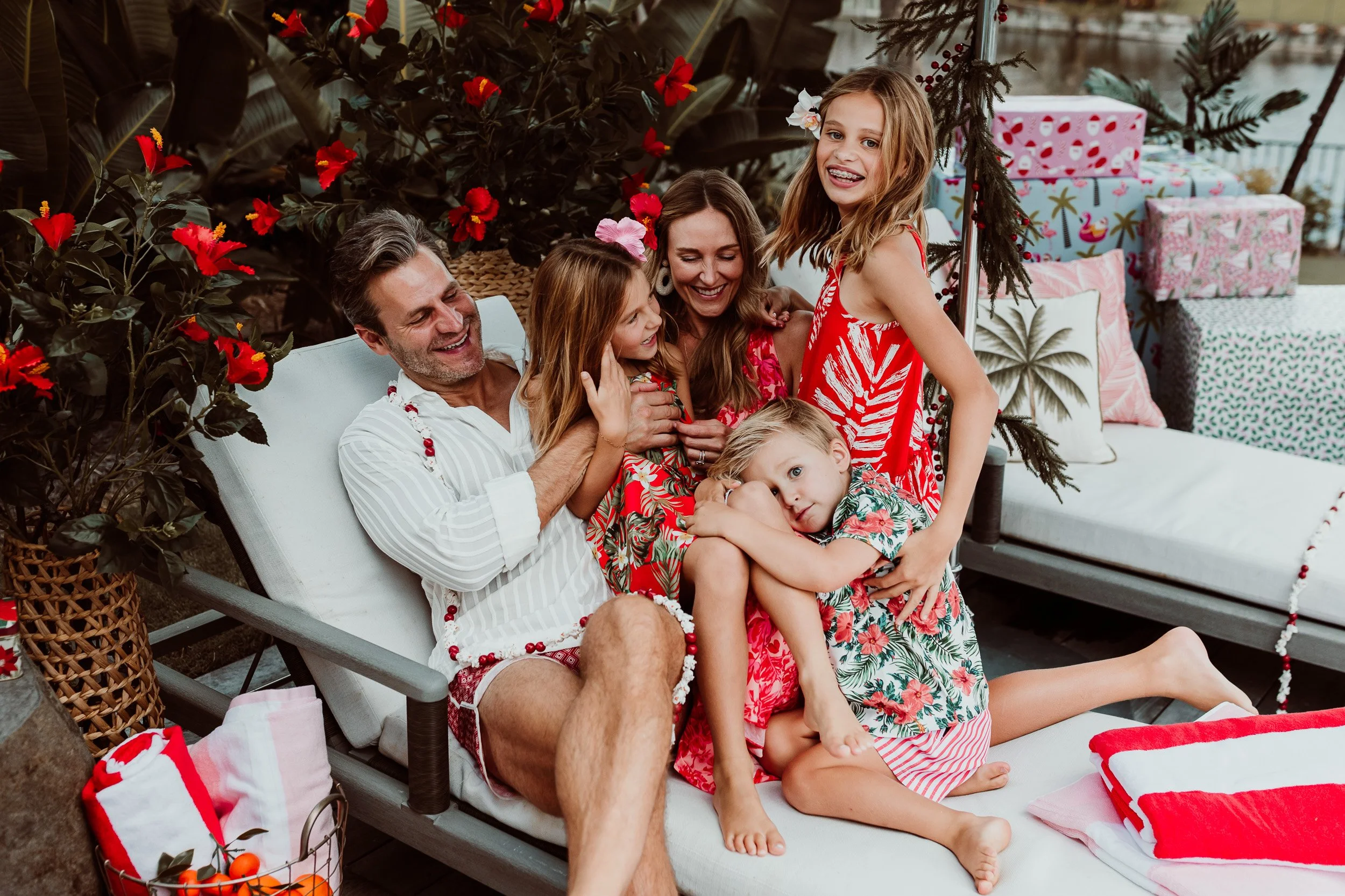 Parents and children laughing together beside the pool