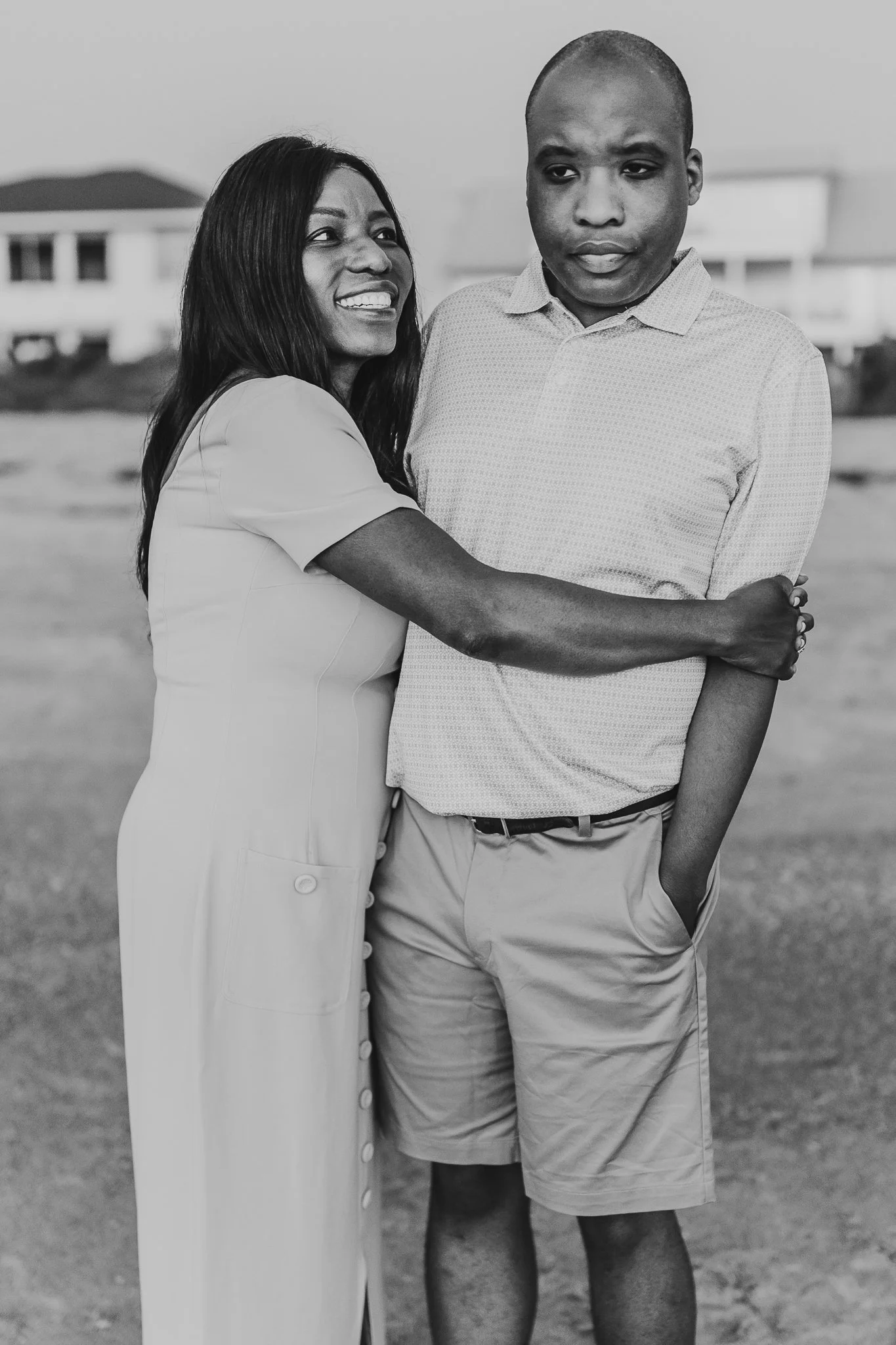 mother hugging adult son and looking at him and smiling