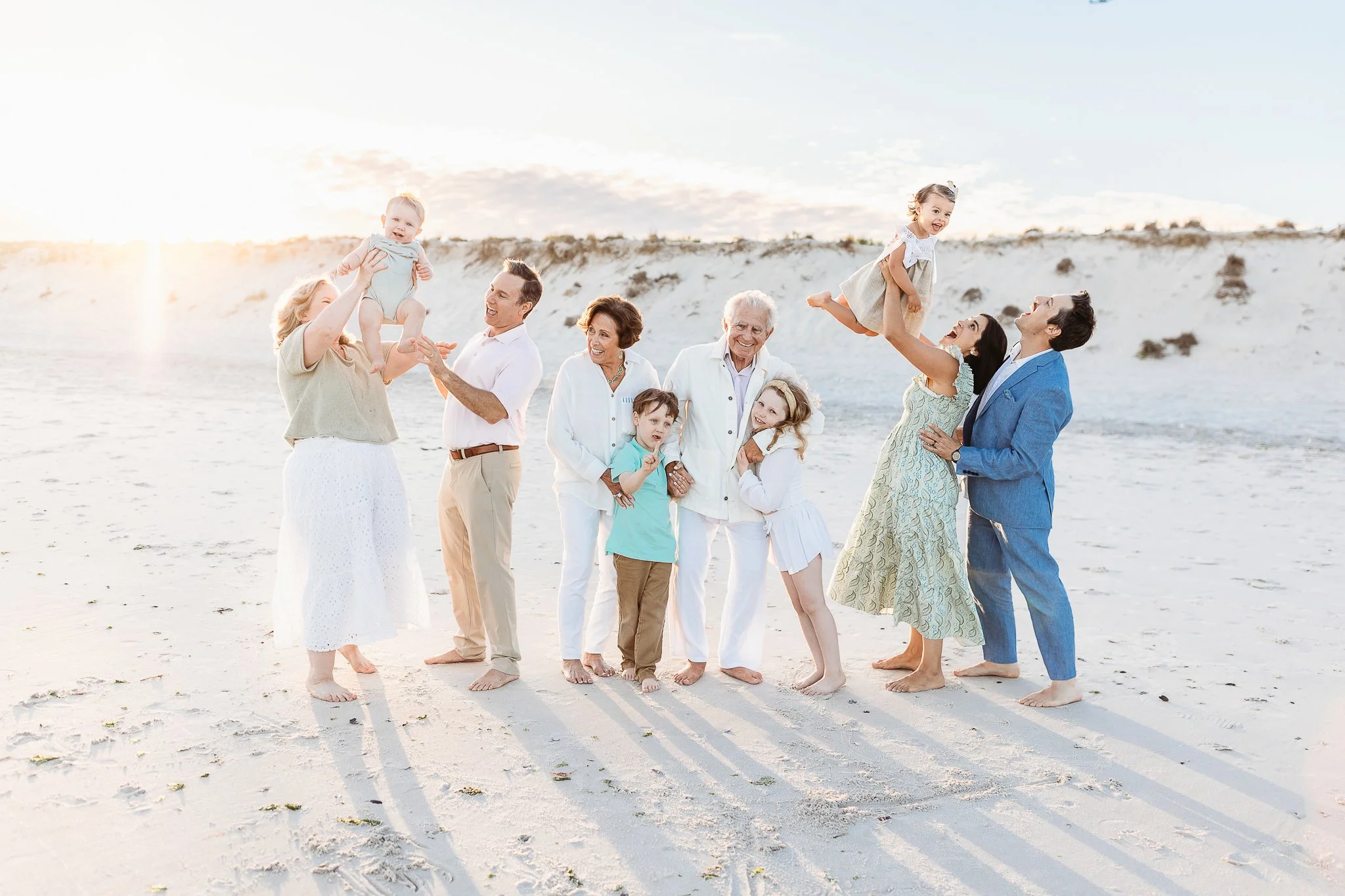 family portrait on a beach with grandparents