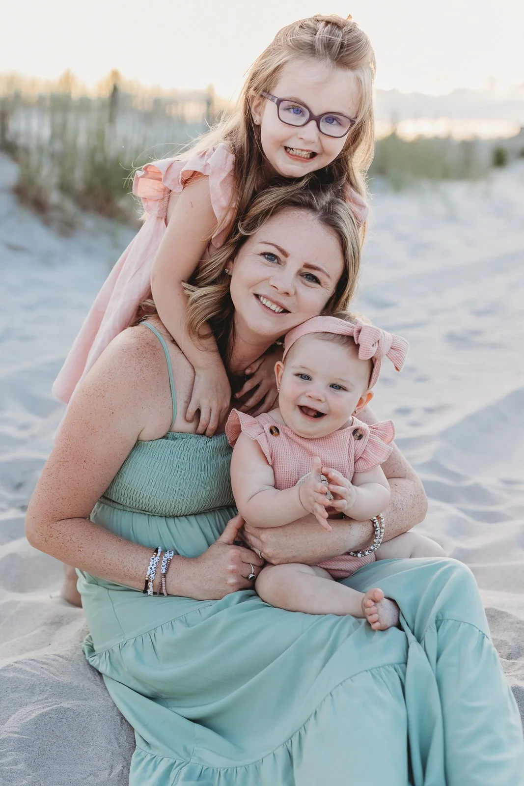 mother and daughters in soft sage and pink for photos at guana reserve middle beach