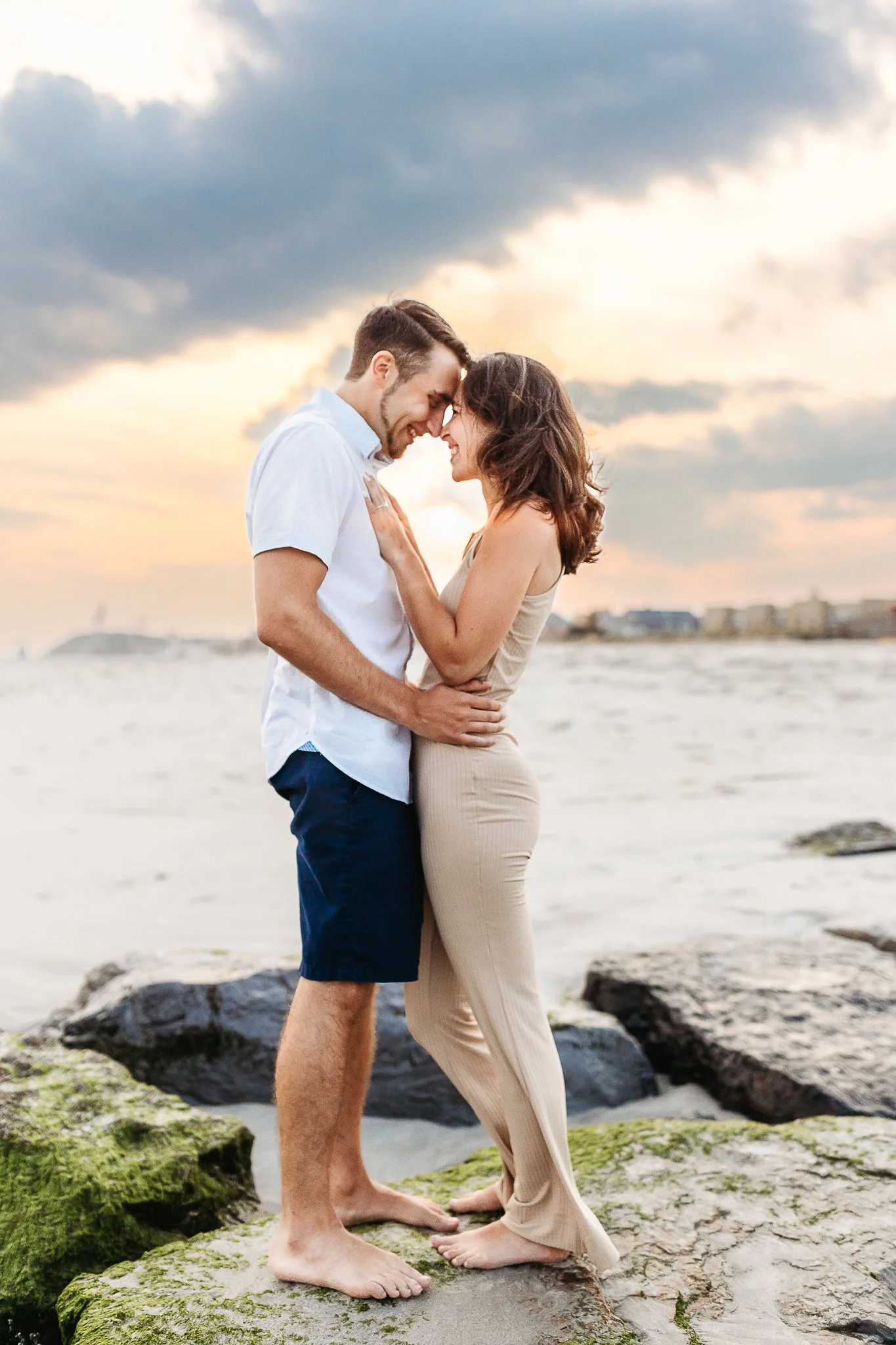 couple on the rocks at a beach after getting engaged in st augustine