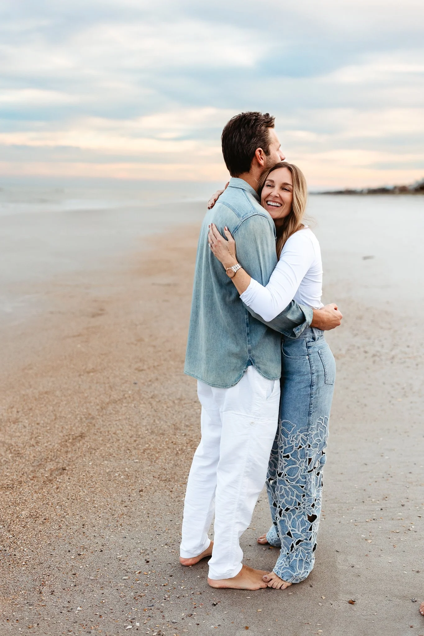 couple embraced and laughing on the beach in Ponte Vedra