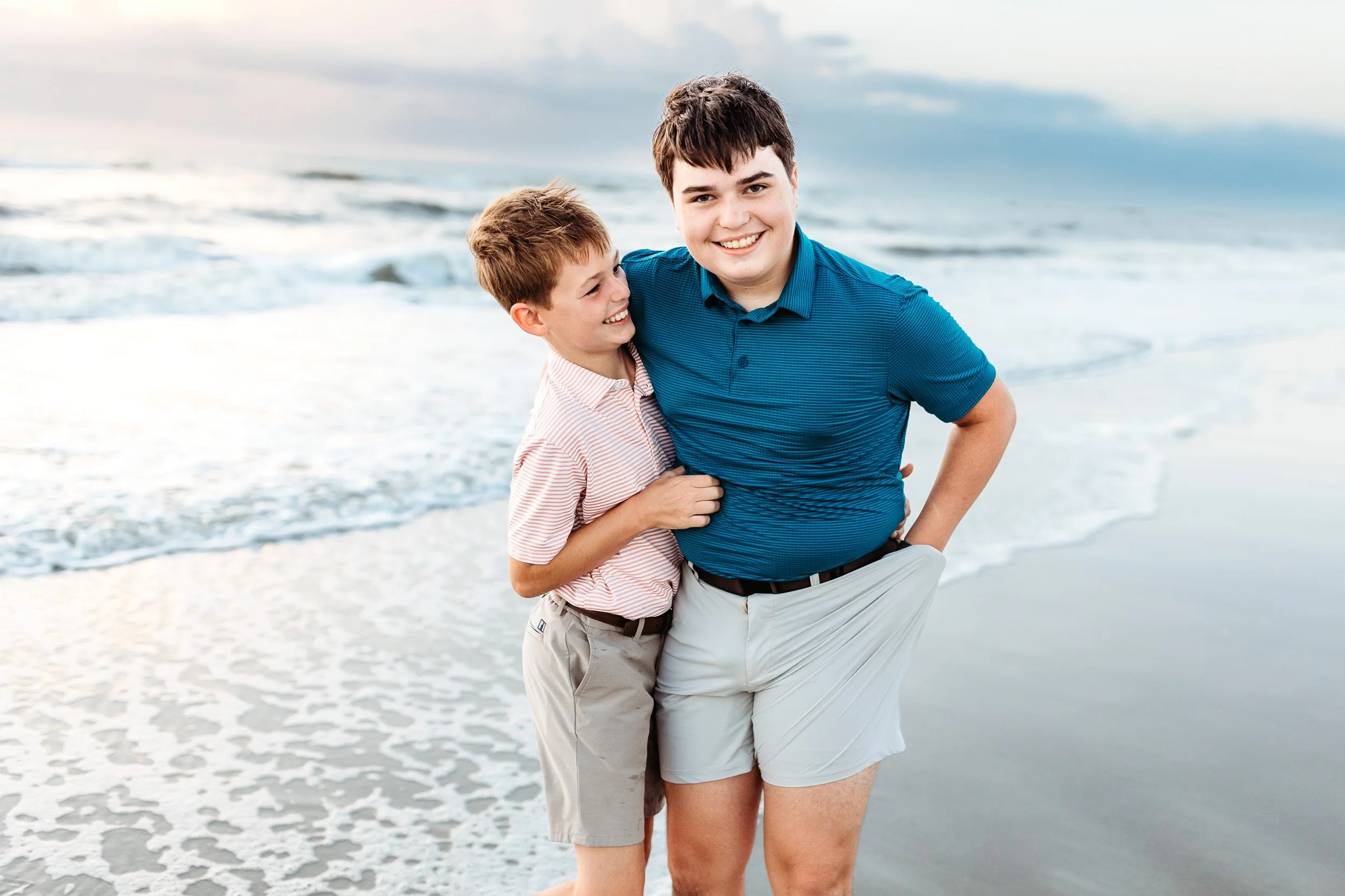 brothers on the beach on vacation during family photos in Jacksonville Beach area