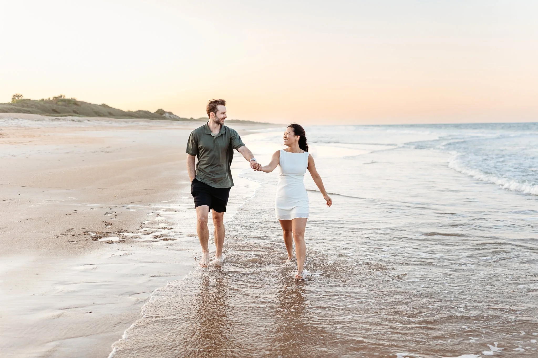 Couple walking along the beach after their engagement in Ponte Vedra Florida