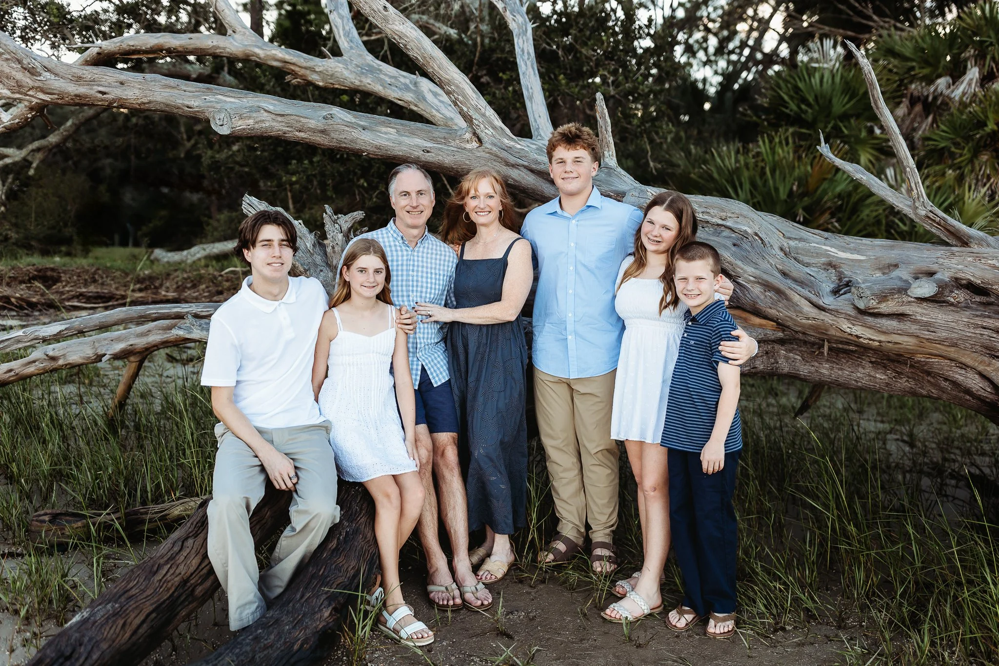 family in front of driftwood on intracoastal for family pics on the water