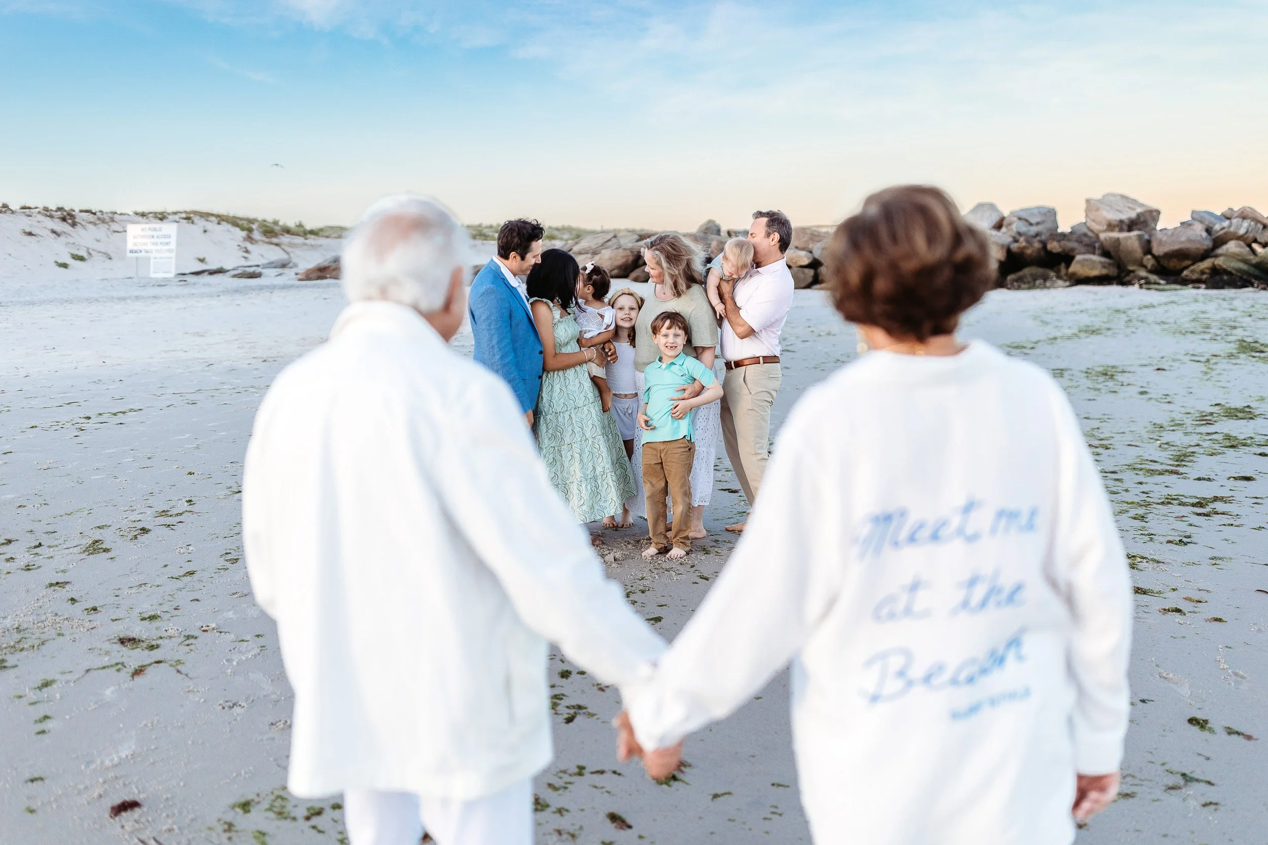 family seen through the hands of grandparents who are blurred in the background 