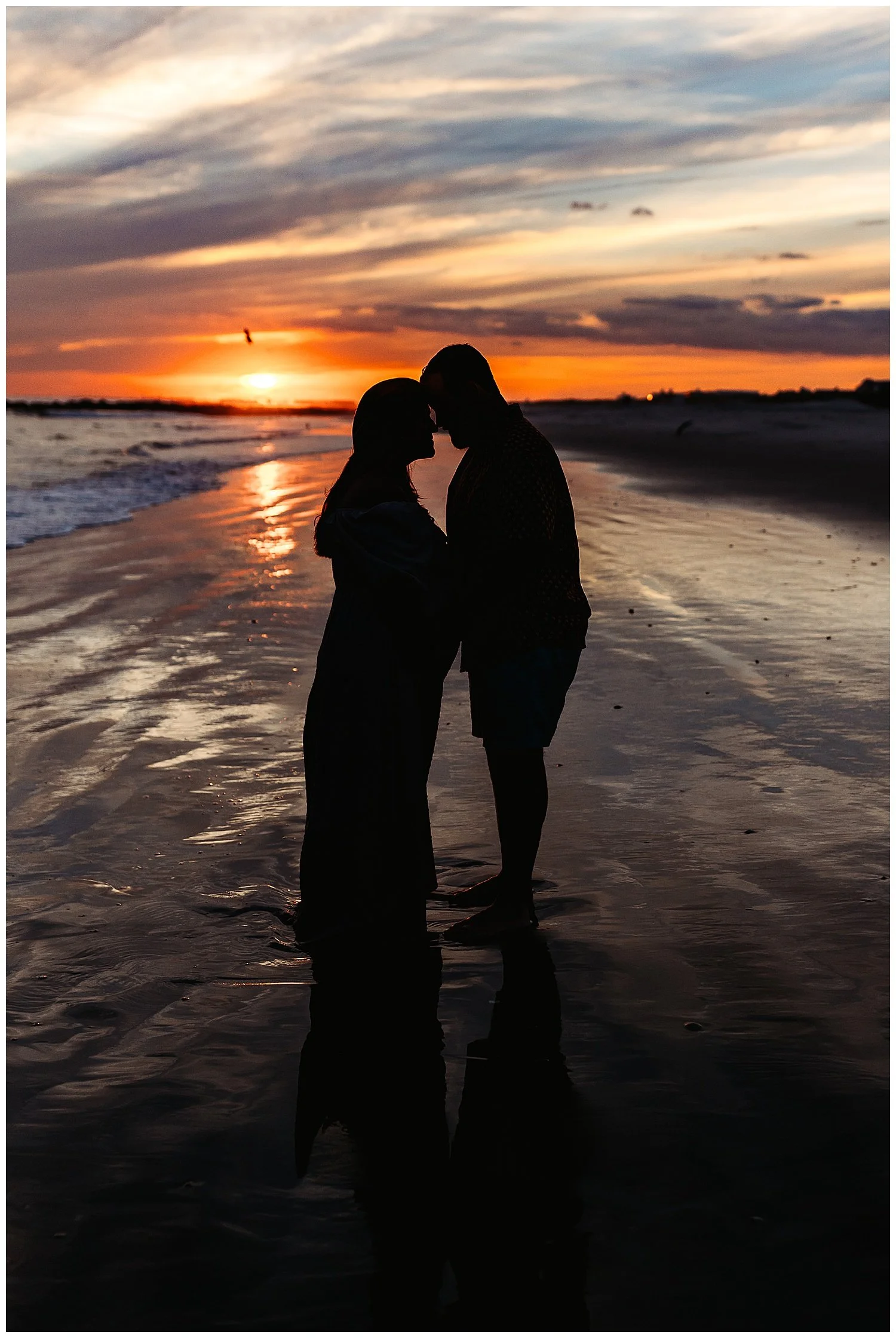 Silhouette maternity portrait at sunset on a Florida beach