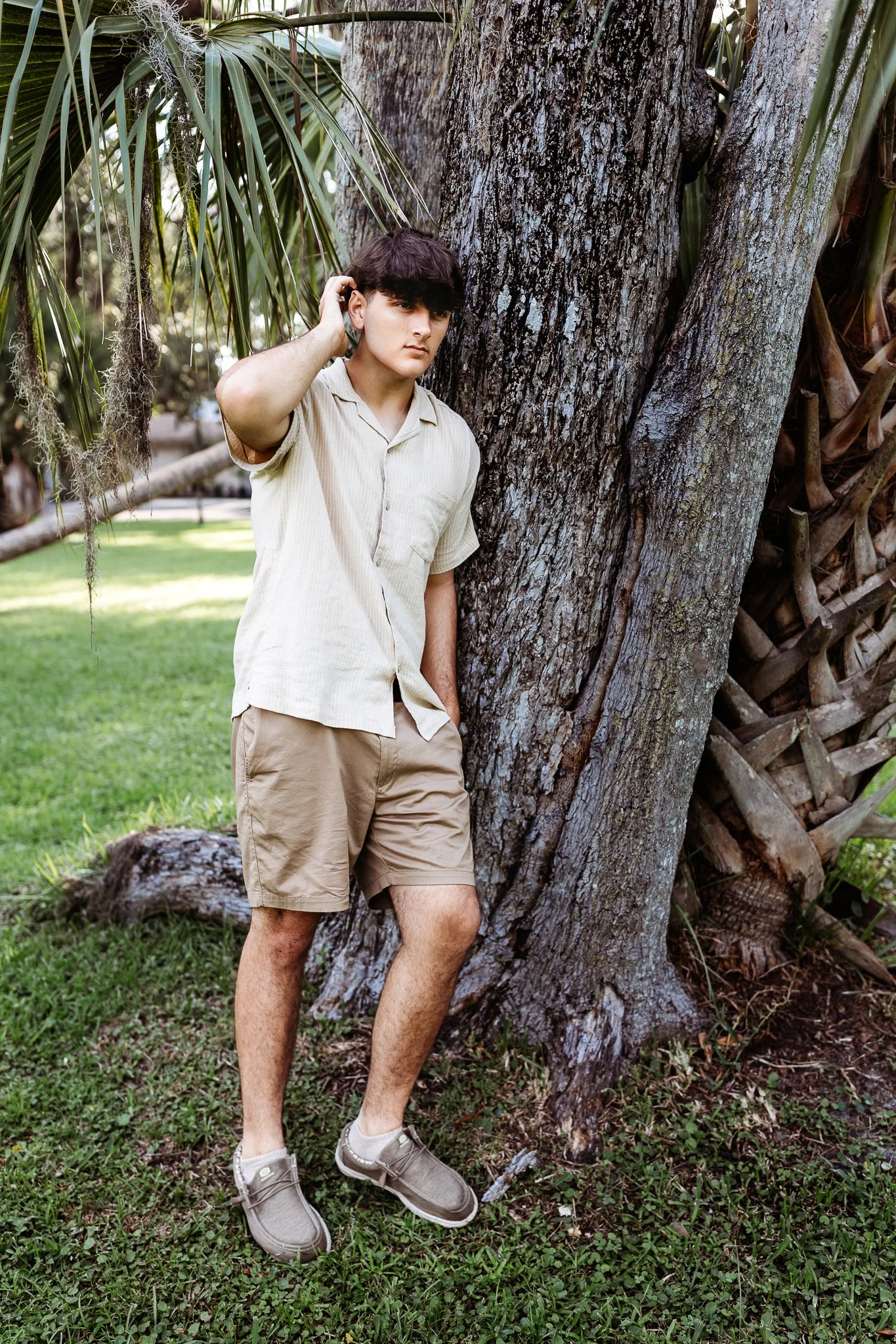 bpy leaning on tree for a senior photo