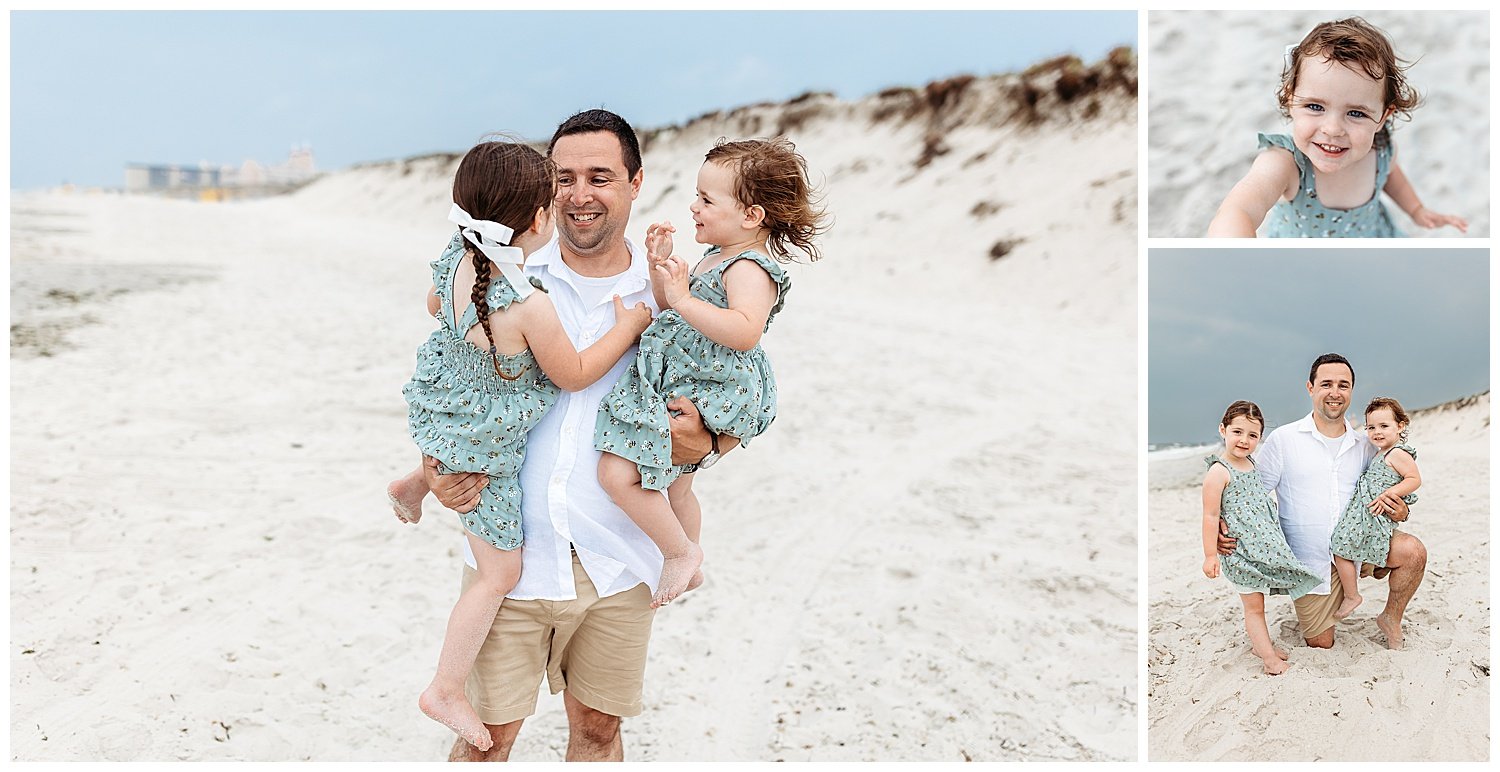 dad in white and tan holding toddler girls and spinning them on the beach grey cloudy sky ocean and dunes