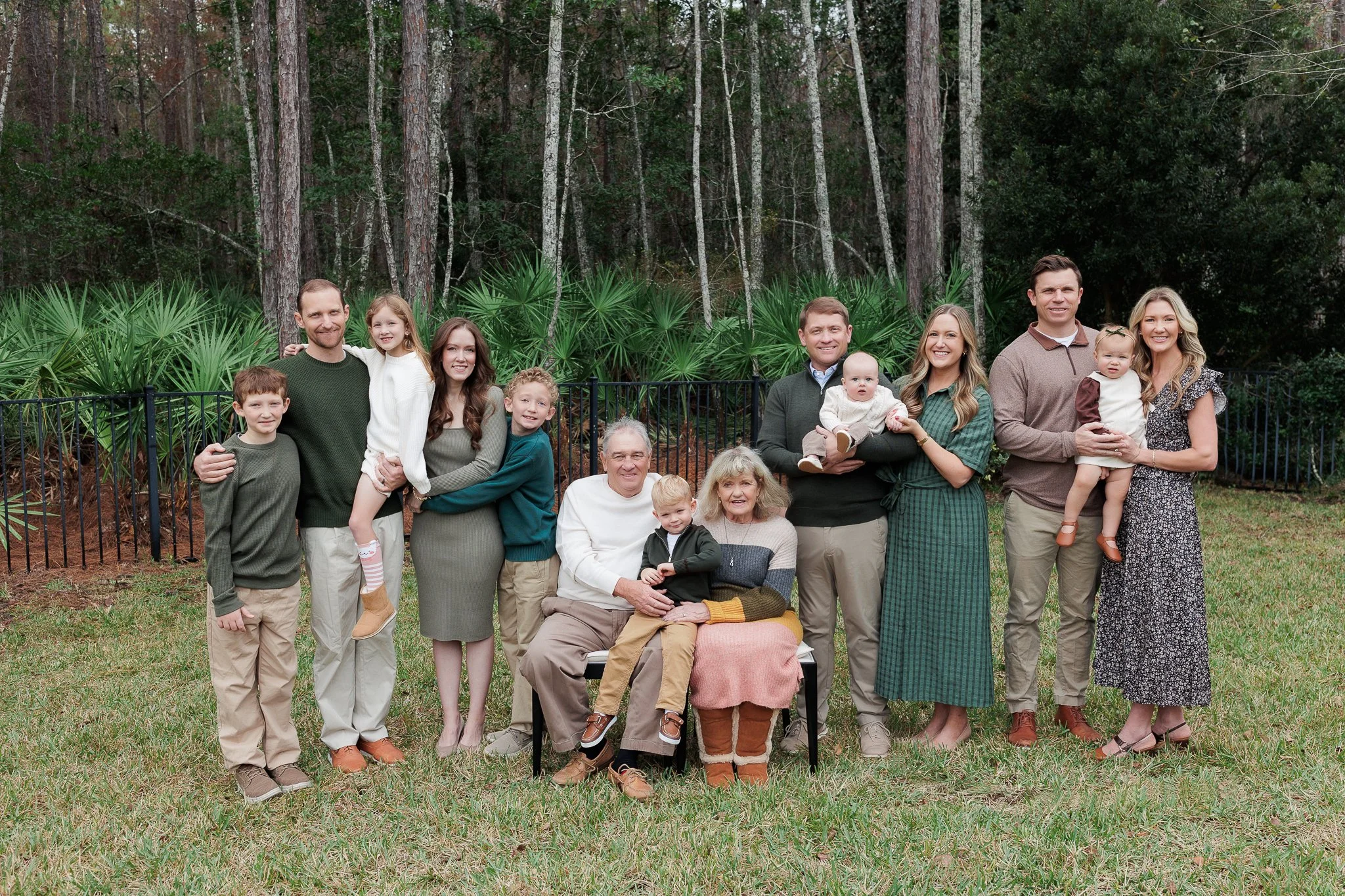 Extended family smiling together during a beach session in Ponte Vedra, photographed by Teresa Geraghty Photography.