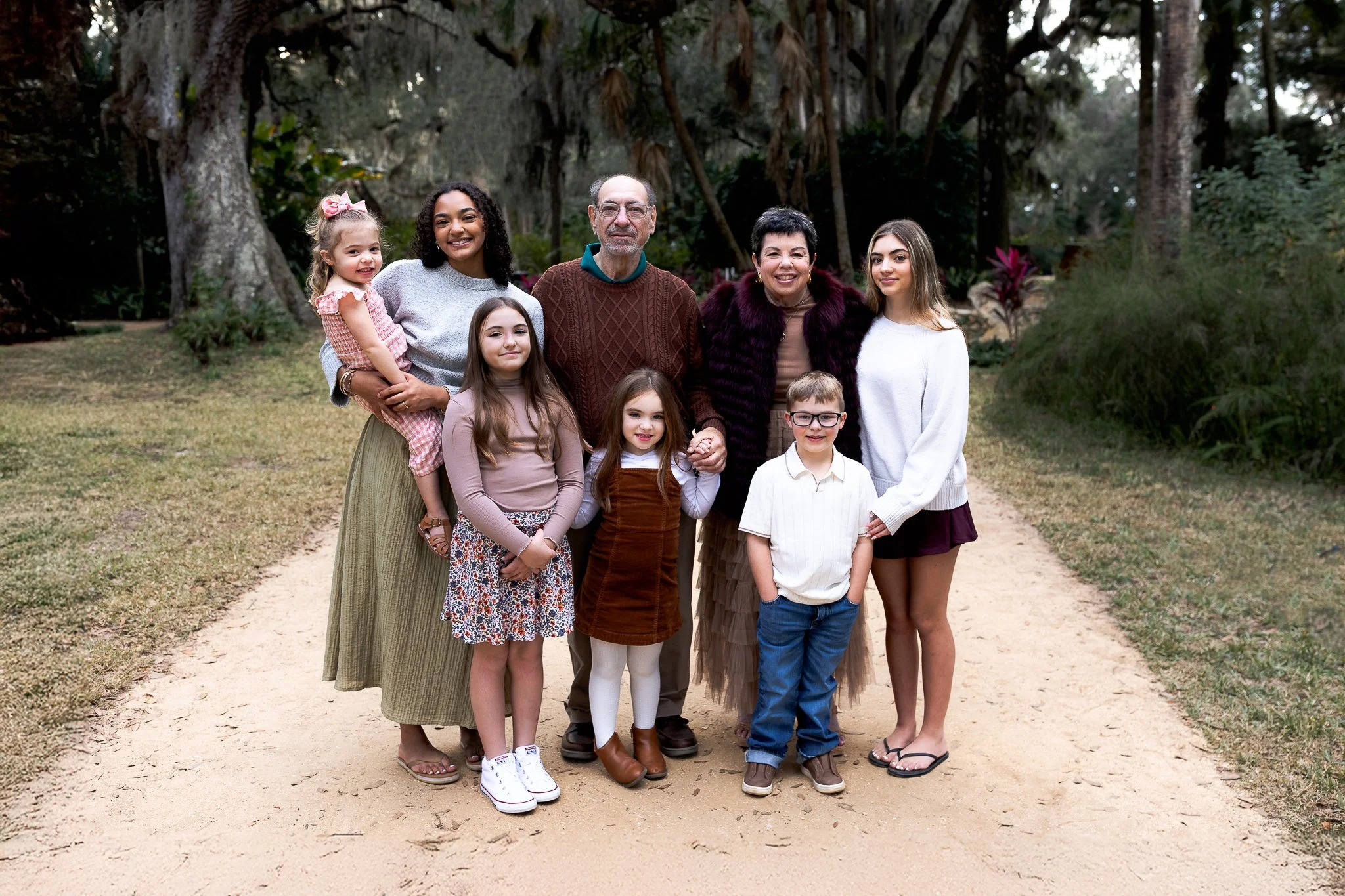 grandparents portrait with grandchildren and oaks behind them