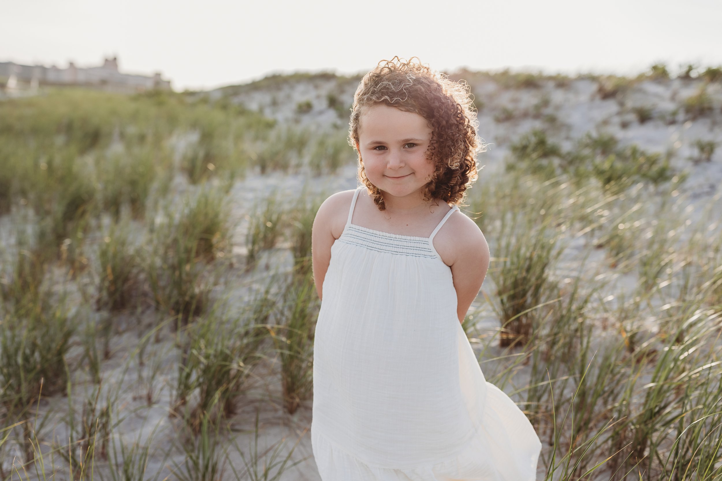little girl in old navy gauze dress on Atlantic Beach fro photos