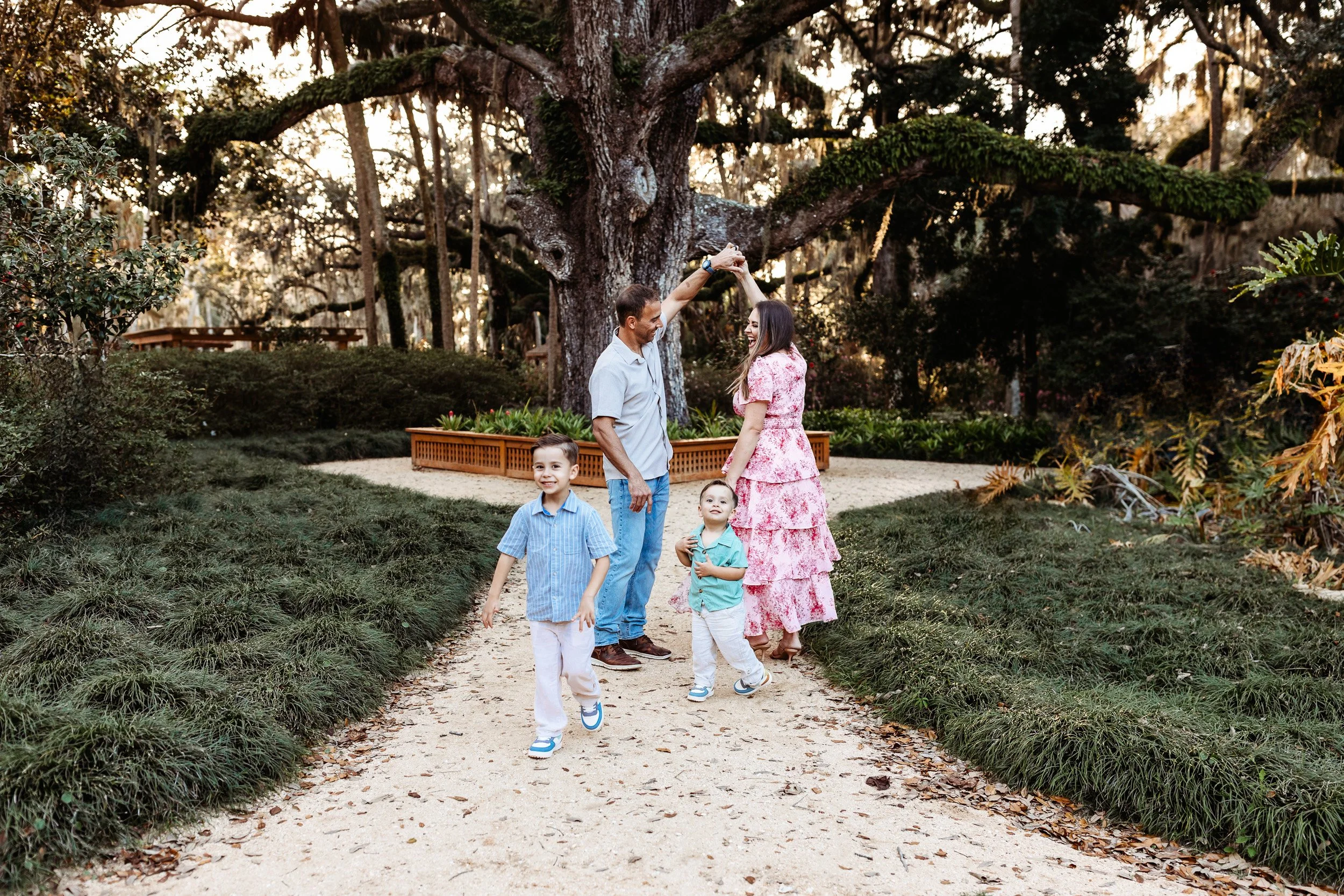 couple dancing in front of a large oak tree at Washington Oaks garden
