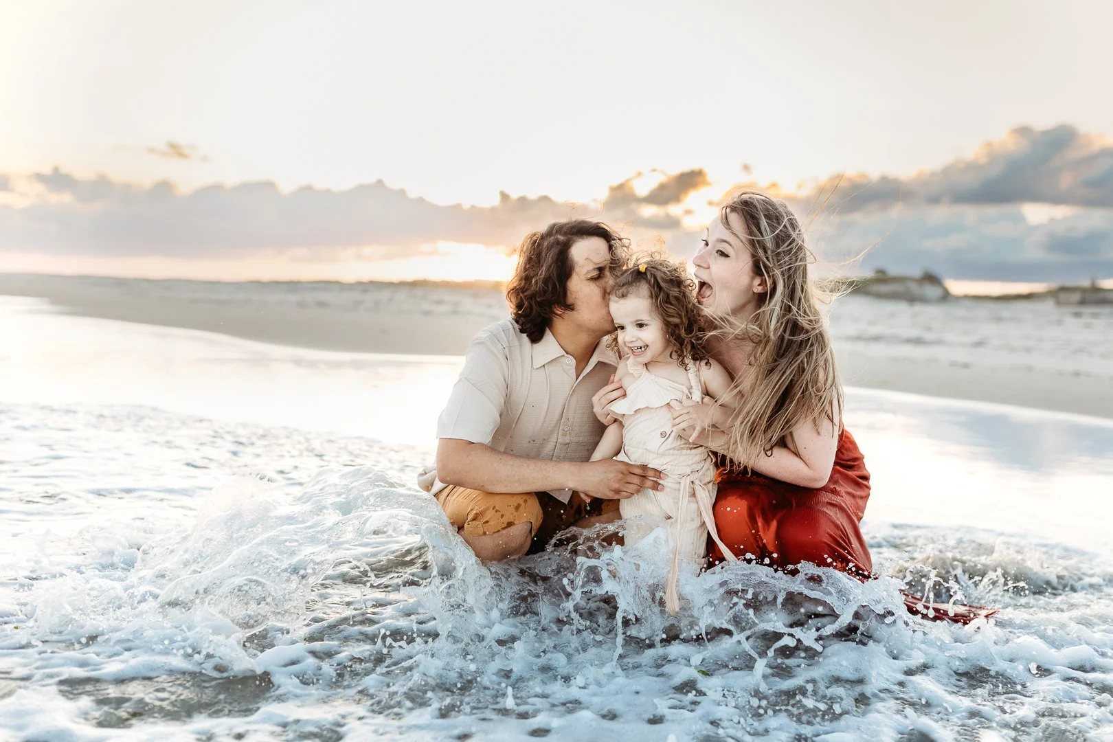 Beach family photo session with coordinated coastal colors in Florida