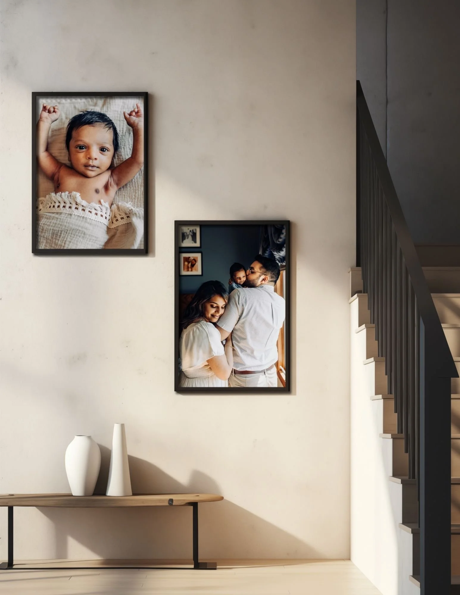 large printed images of a newborn baby and family on a wall from their in home newborn photo session with a Jacksonville photographer