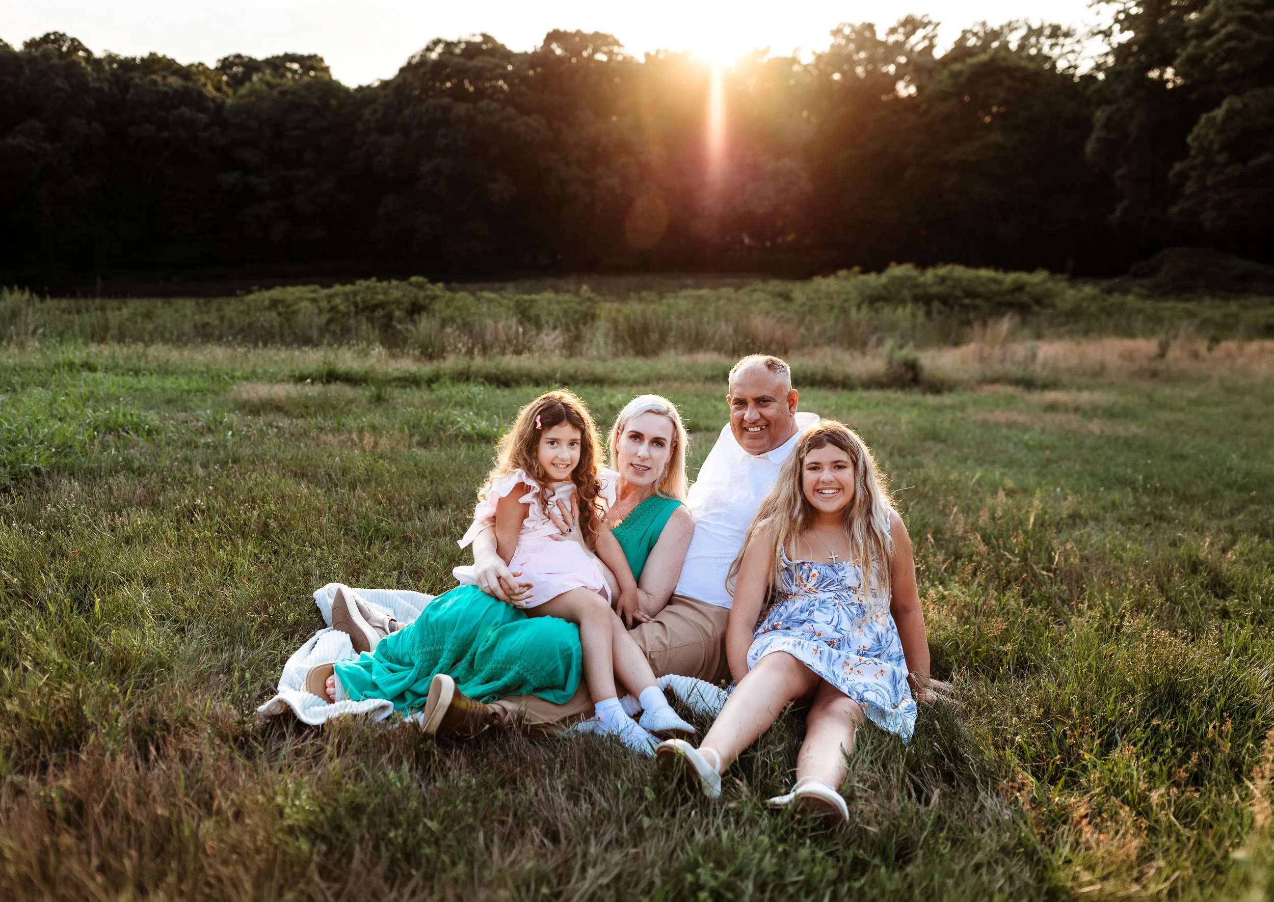 traditional family photo in a field at sunset