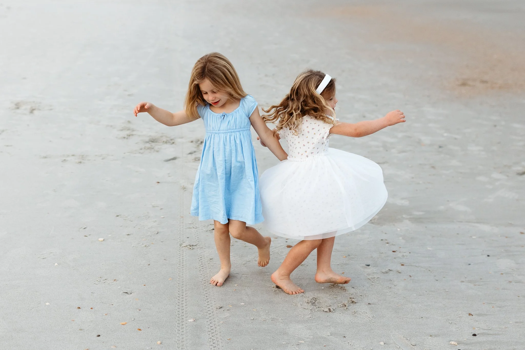 children dancing on the beach during a session at sunset on the beach